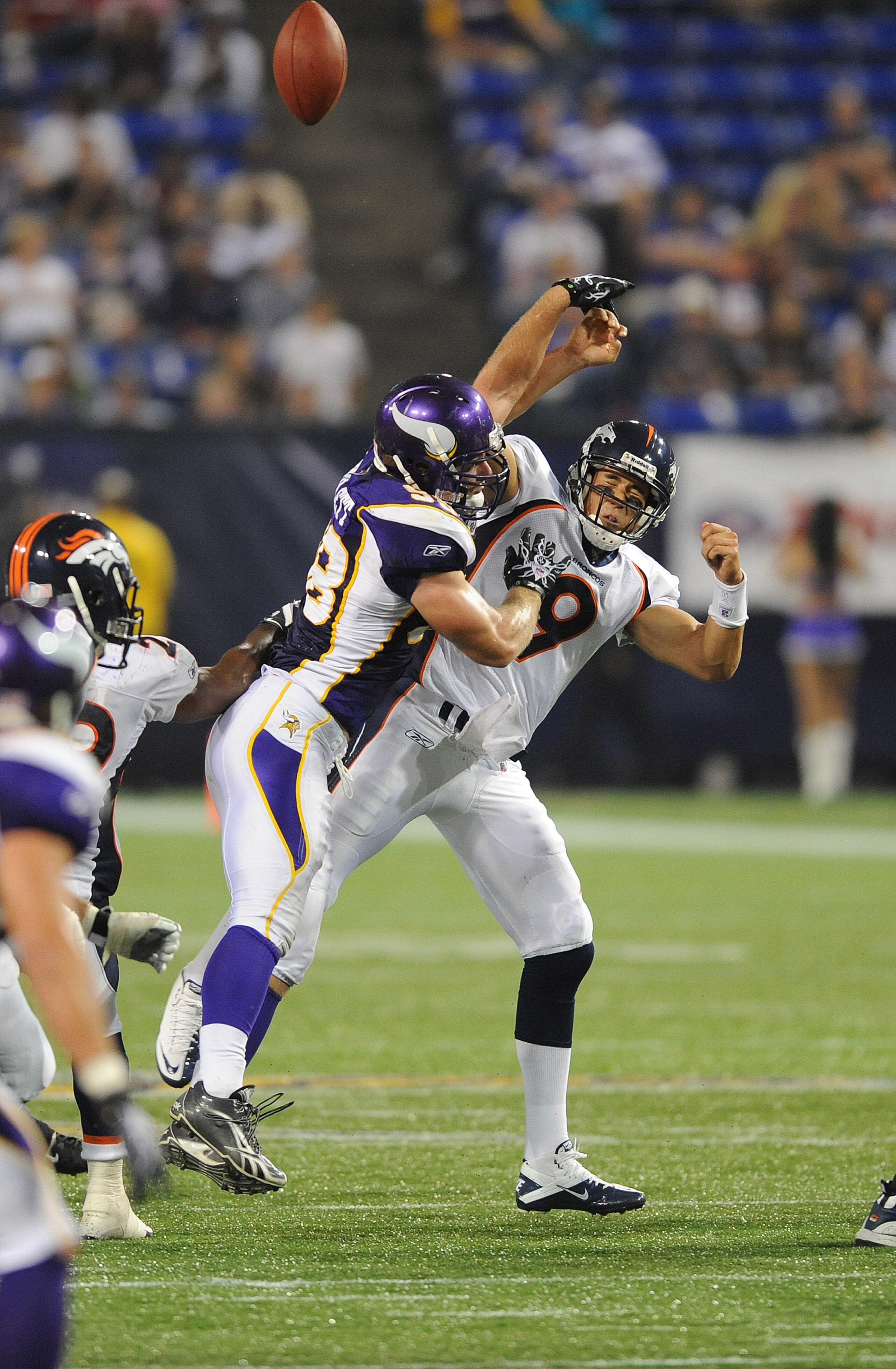 MINNEAPOLIS - SEPTEMBER 02:  Brady Quinn #9 of the Denver Broncos passes the ball as Nate Triplett #58 of the Minnesota Vikings defends during an NFL preseason game at the Mall of America Field at Hubert H. Humphrey Metrodome, on September 2, 2010 in Minn