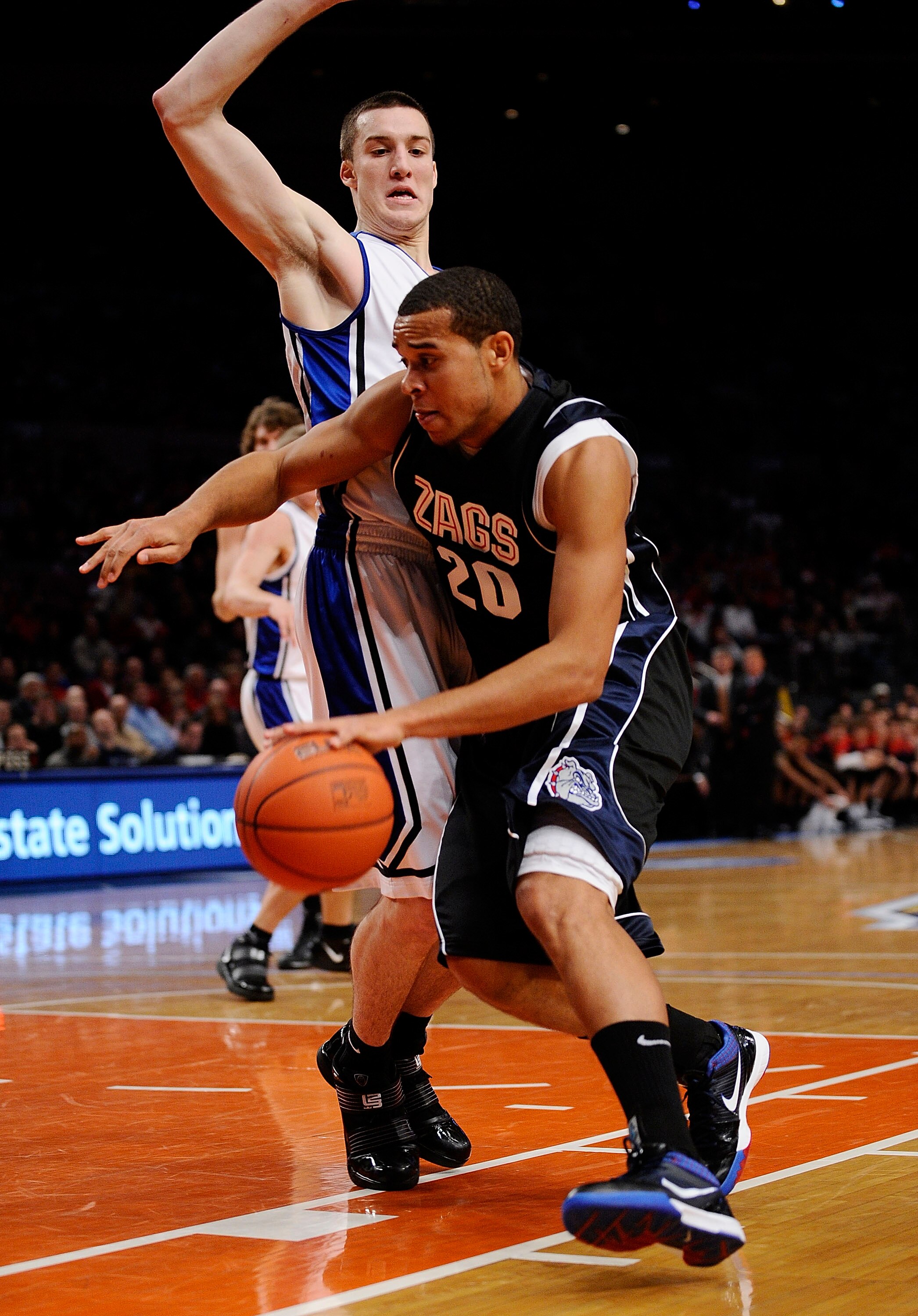 NEW YORK - DECEMBER 19:   Elias Harris #20 of the Gonzaga Bulldogs drives around Miles Plumlee #21 of the Duke Blue Devils in the first half of the Aeropostale Classic at Madison Square Garden on December 19, 2009 in New York City.  (Photo by Jeff Zelevan