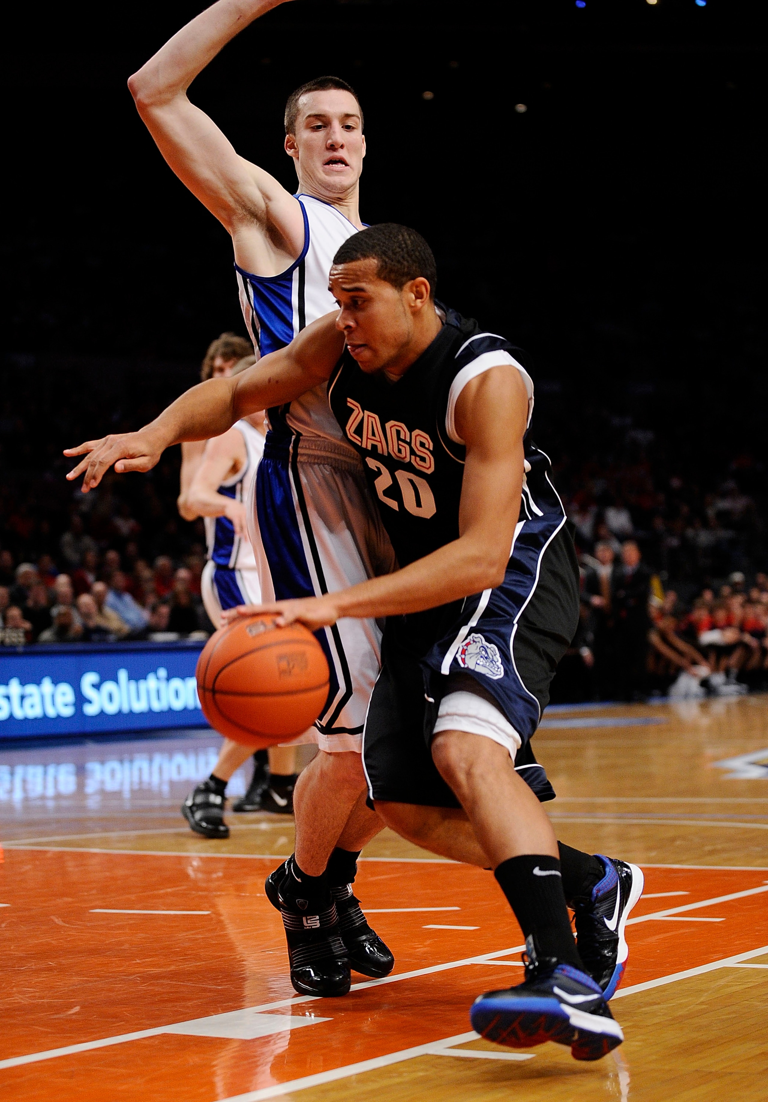 NEW YORK - DECEMBER 19:   Elias Harris #20 of the Gonzaga Bulldogs drives around Miles Plumlee #21 of the Duke Blue Devils in the first half of the Aeropostale Classic at Madison Square Garden on December 19, 2009 in New York City.  (Photo by Jeff Zelevan