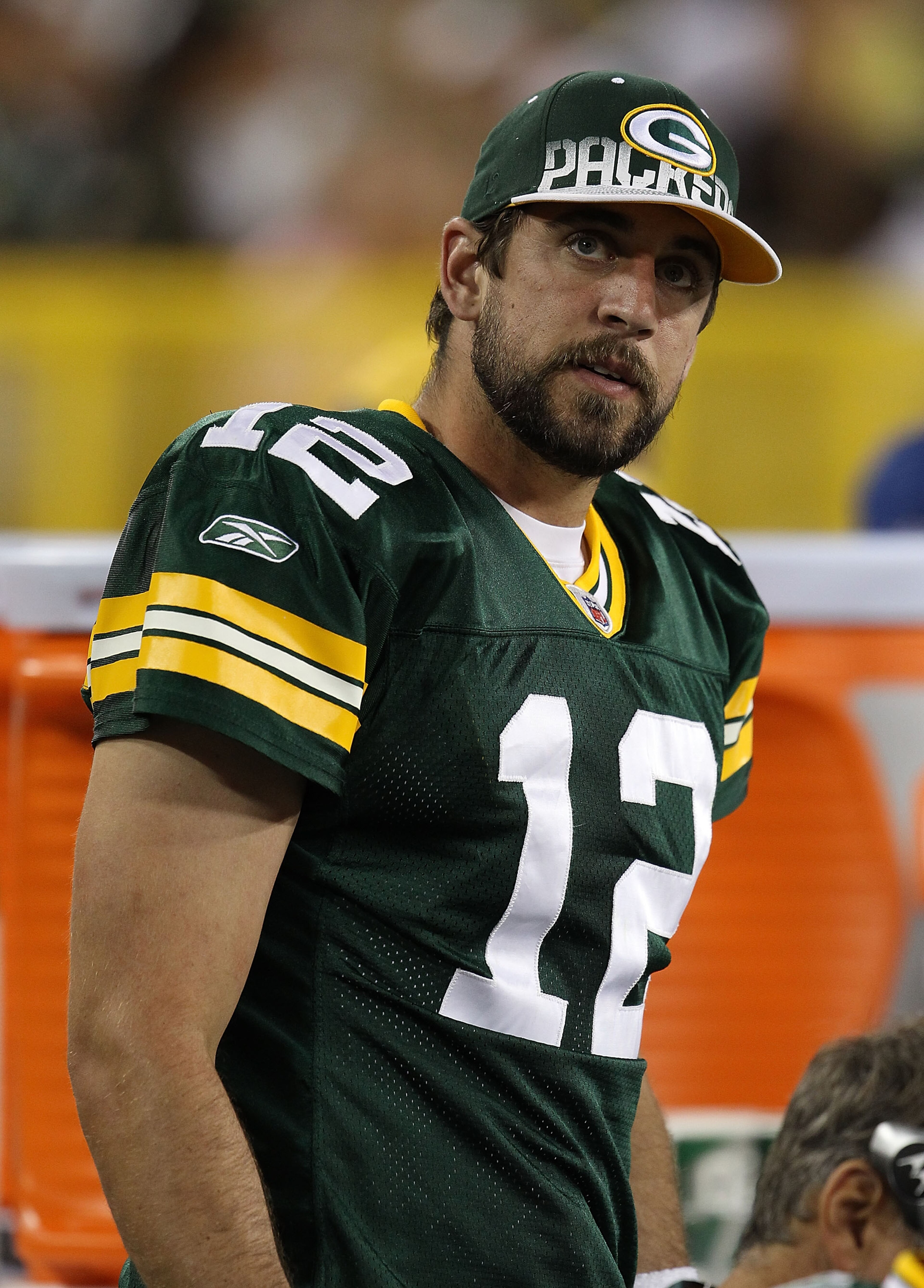 GREEN BAY, WI - AUGUST 26: Aaron Rodgers #12 of the Green Bay Packers watches as his teammates take on the Indianapolis Colts during a preseason game at Lambeau Field on August 26, 2010 in Green Bay, Wisconsin. The Packers defeated the Colts 59-24. (Photo GREEN BAY, WI - AUGUST 26: Aaron Rodgers #12 of the Green Bay Packers watches as his teammates take on the Indianapolis Colts during a preseason game at Lambeau Field on August 26, 2010 in Green Bay, Wisconsin. The Packers defeated the Colts 59-24. (Photo