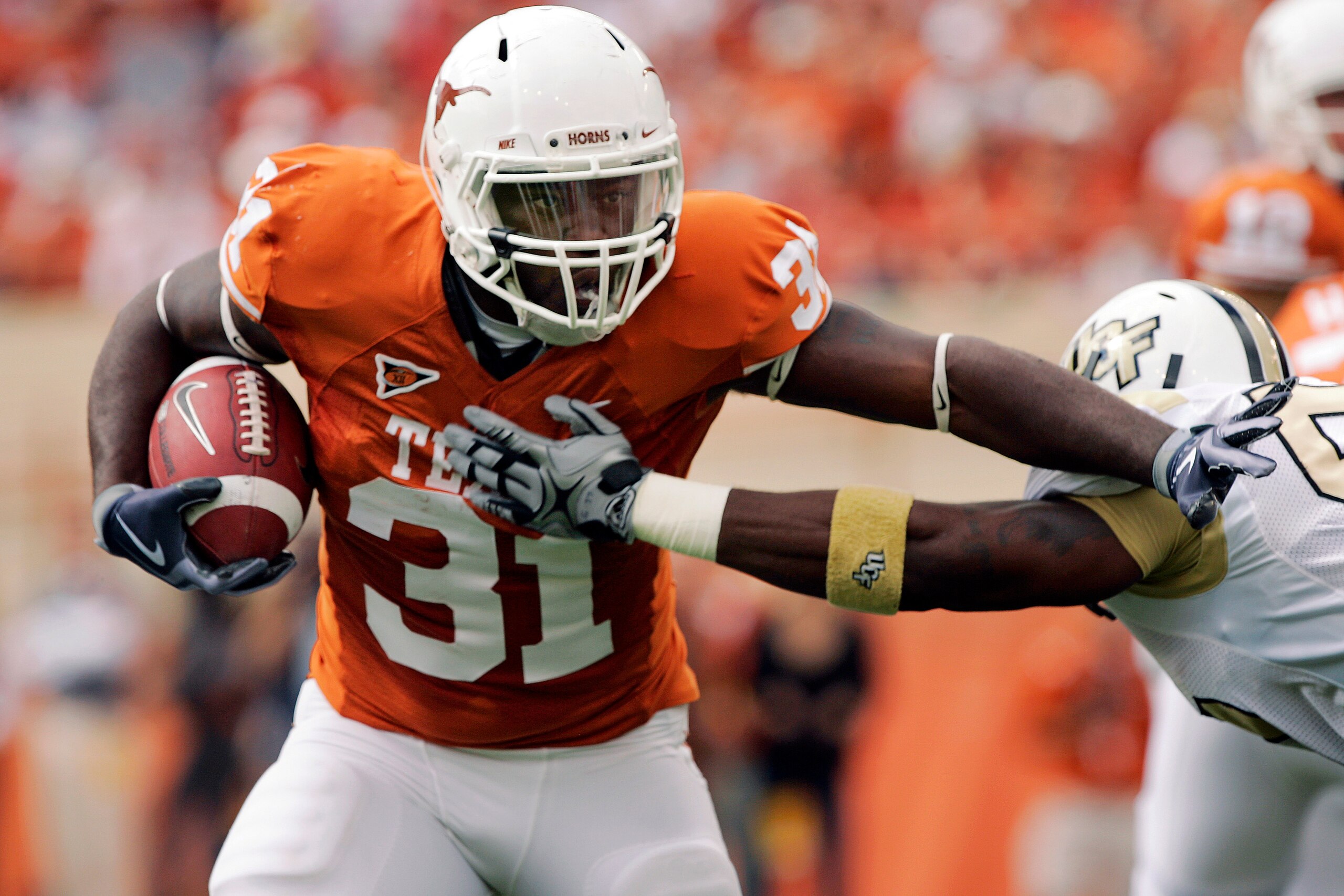 AUSTIN, TX - NOVEMBER 07:  Running back Cody Johnson #31 of the Texas Longhorns stiff arms a defender against the UCF Knights on November 7, 2009 at Darrell K Royal - Texas Memorial Stadium in Austin, Texas.  Texas leads 14-3 at the half.  (Photo by Brian