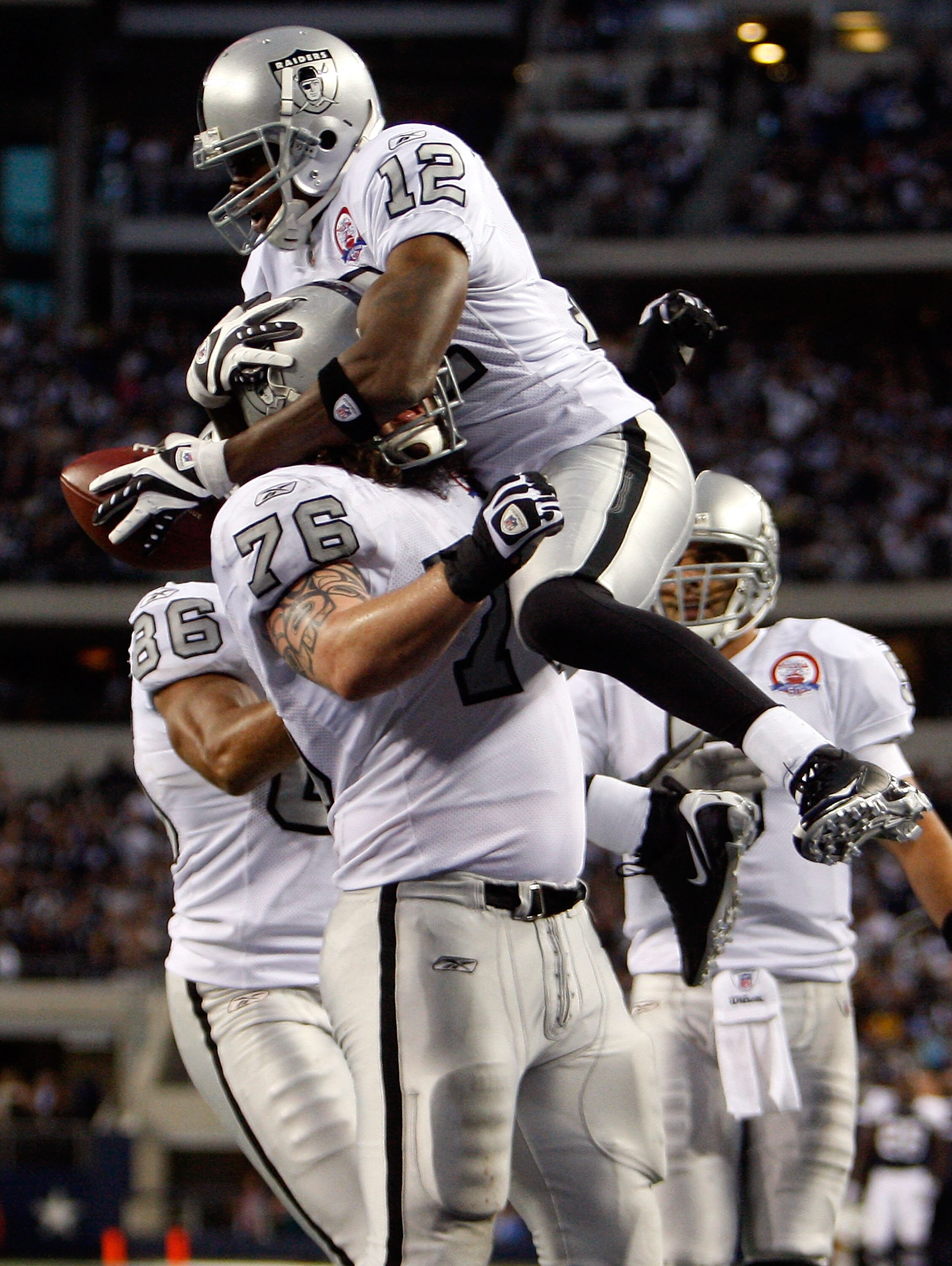 ARLINGTON, TX - NOVEMBER 26:  Wide receiver Darrius Heyward-Bey #12 of the Oakland Raiders celebrates a touchdown with Robert Gallery #76 against the Dallas Cowboys at Cowboys Stadium on November 26, 2009 in Arlington, Texas.  (Photo by Ronald Martinez/Ge