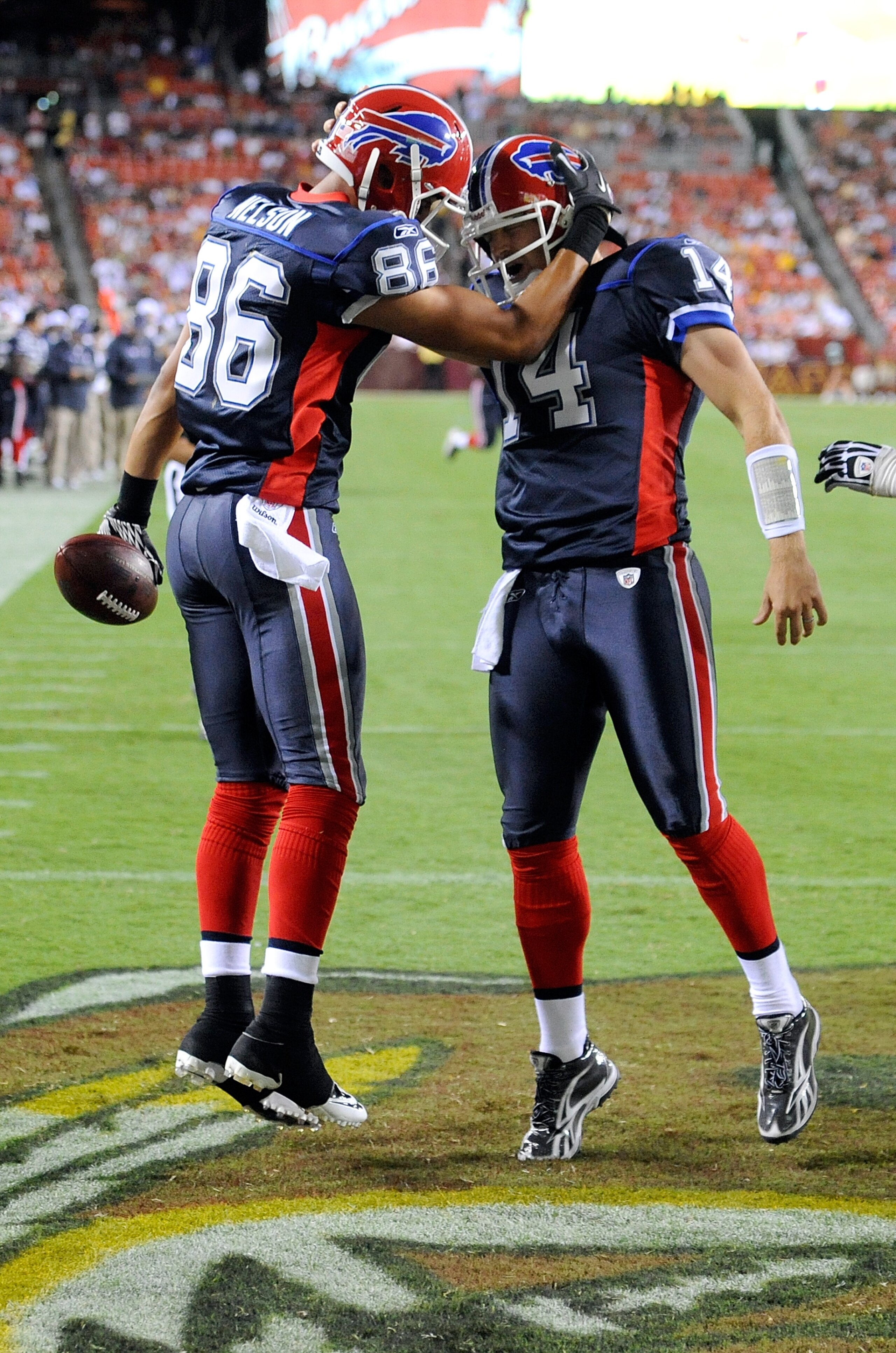 LANDOVER, MD - AUGUST 13:  David Nelson #86 celebrates with Ryan Fitzpatrick #14 of the Buffalo Bills after scoring in the third quarter of the preseason game against the Washington Redskins at FedEx Field on August 13, 2010 in Landover, Maryland.  (Photo