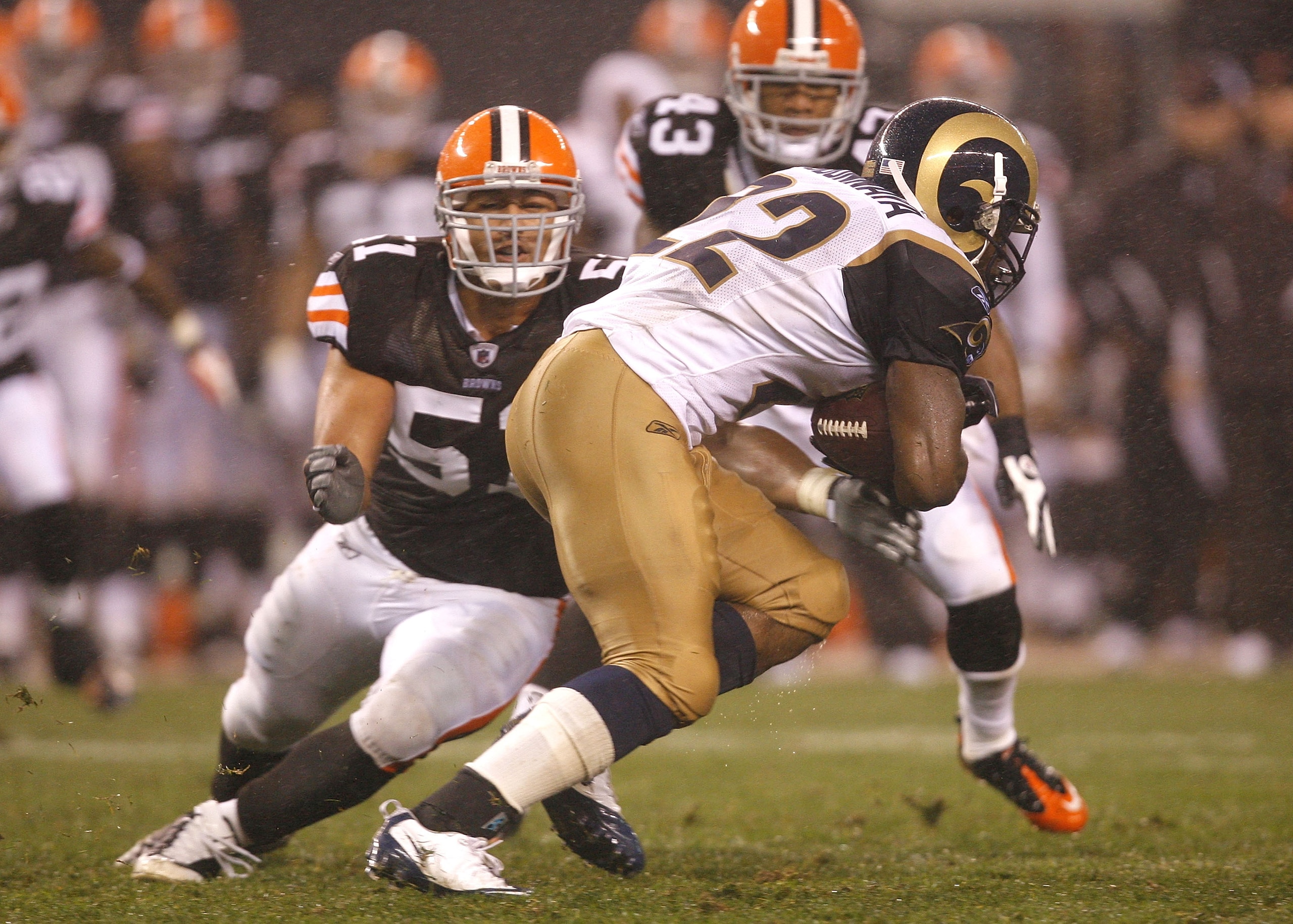 CLEVELAND - AUGUST 21:  Chris Ogbonnaya #22 of the St. Louis Rams runs by Chris Gocong #51 of the Cleveland Browns at Cleveland Browns Stadium on August 21, 2010 in Cleveland, Ohio.  (Photo by Matt Sullivan/Getty Images)