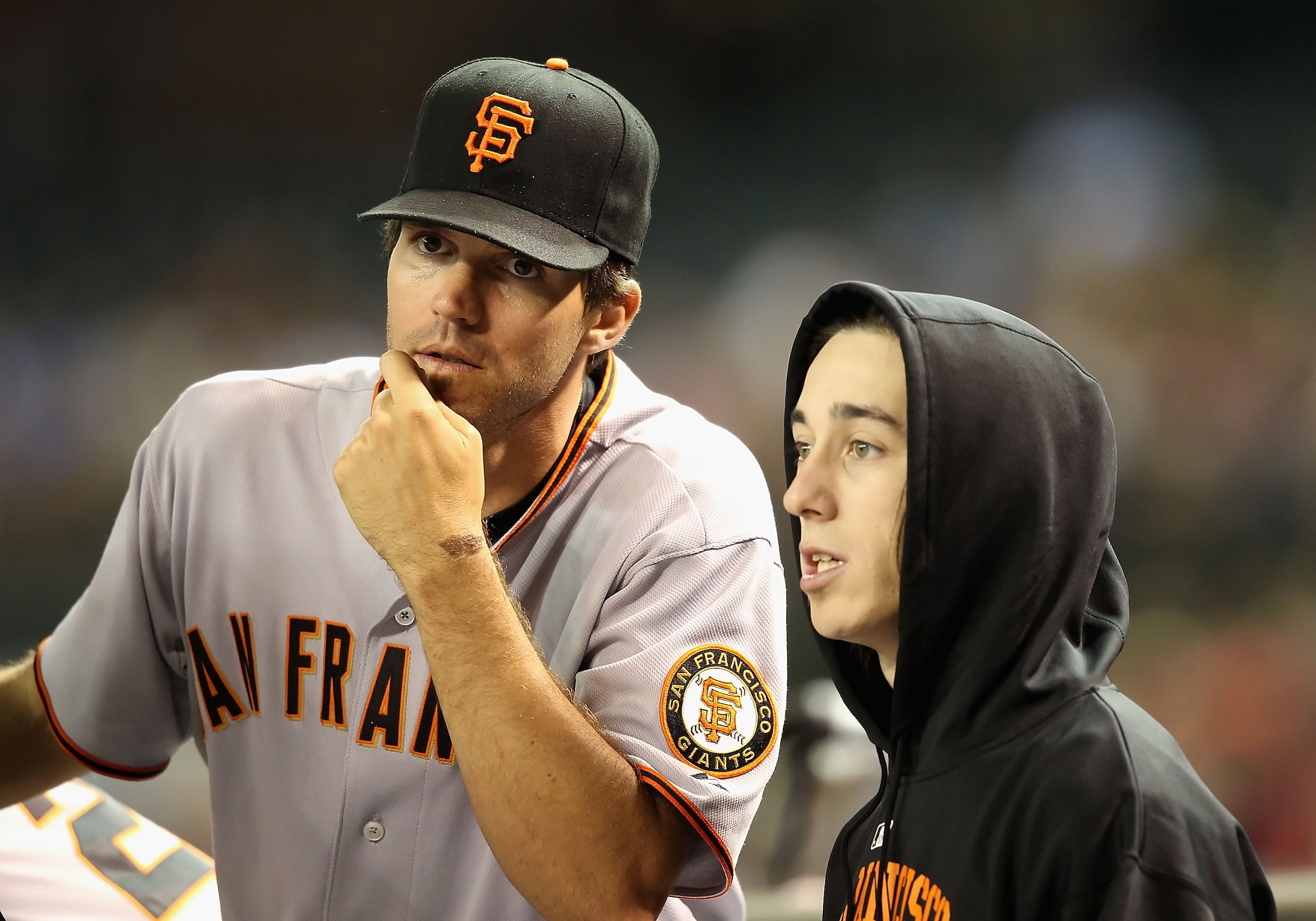 PHOENIX - MAY 20:  Pitchers Barry Zito #75 and Tim Lincecum #55 of the San Francisco Giants talk in the dugout during the Major League Baseball game against the Arizona Diamondbacks at Chase Field on May 20, 2010 in Phoenix, Arizona.  (Photo by Christian