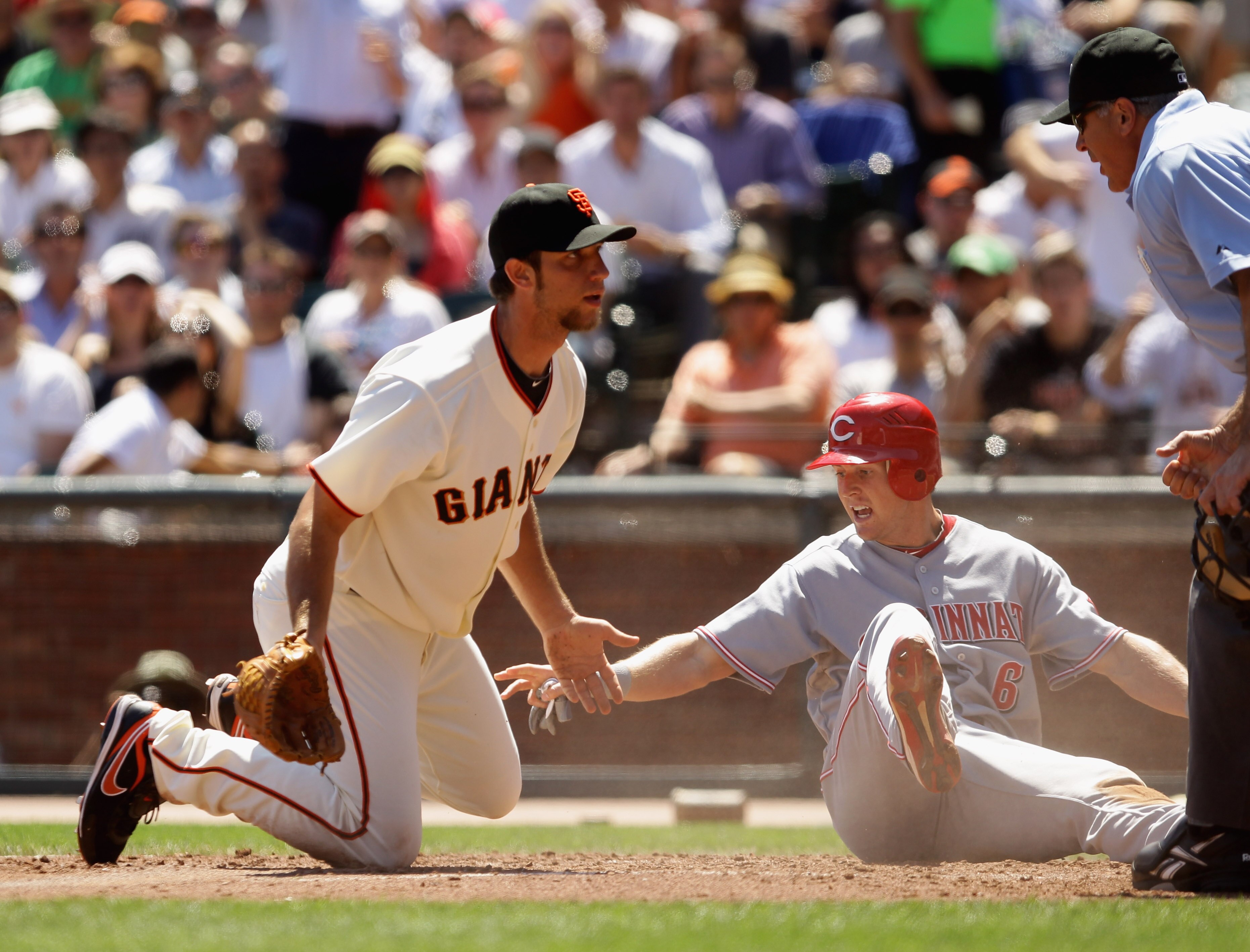 SAN FRANCISCO - AUGUST 25:  Drew Stubbs #6 of the Cincinnati Reds points to the dropped ball by Madison Bumgarner #40 of the San Francisco Giants that allowed Stubbs to score in third inning at AT&T Park on August 25, 2010 in San Francisco, California.  (
