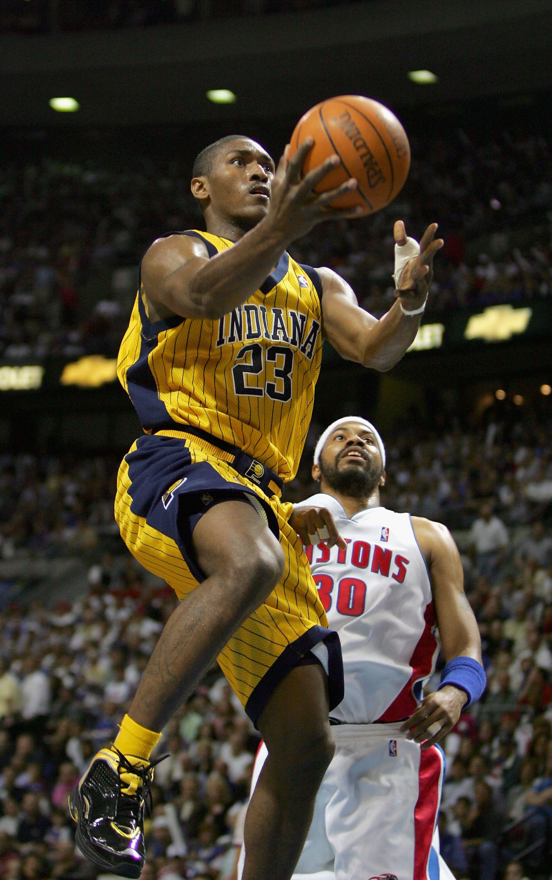 AUBURN HILLS, MI - JUNE 1:  Ron Artest #23 of the Indiana Pacers goes to the basket past Rasheed Wallace #30 of the Detroit Pistons in Game six of the Eastern Conference Finals during the 2004 NBA Playoffs at The Palace of Auburn Hills on June 1, 2004 in 