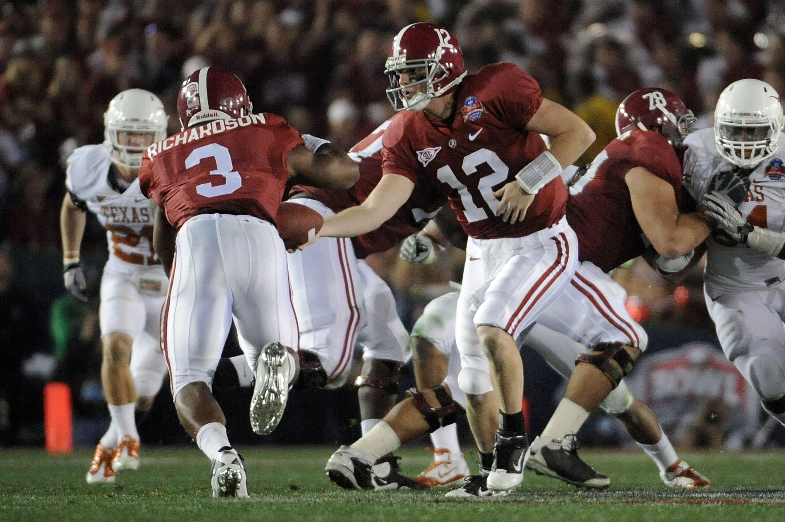 PASADENA, CA - JANUARY 07:  Quarterback Greg McElroy #12 of the Alabama Crimson Tide hands the ball off to running back Trent Richardson #3 for a 49-yard touchdown against the Texas Longhorns in the second quarter of the Citi BCS National Championship gam