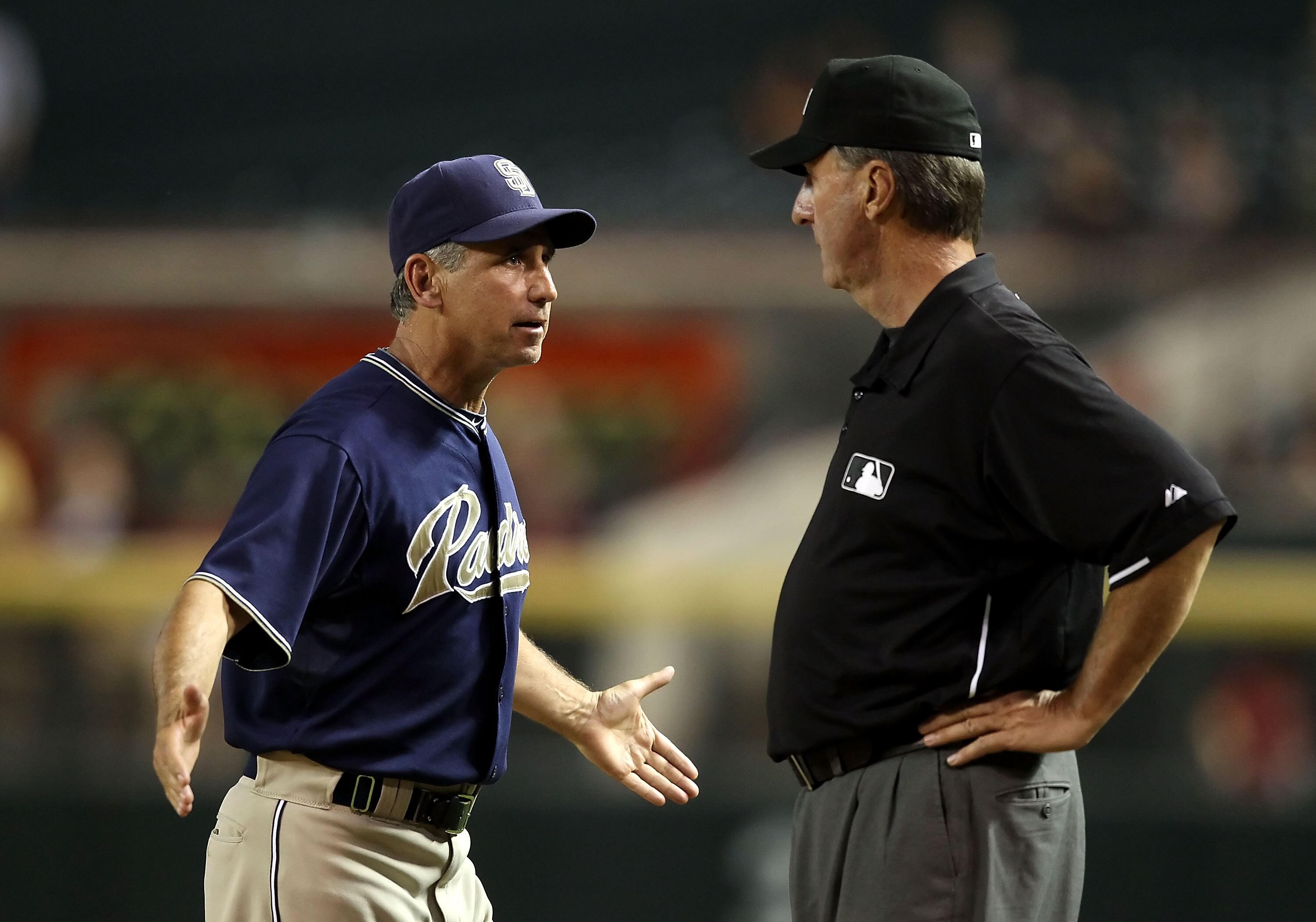 PHOENIX - AUGUST 30:  Manager Bud Black of the San Diego Padres reacts to first base umpire Tim McClelland after a disputed call during the fifth inning of the Major League Baseball game against the Arizona Diamondbacks at Chase Field on August 30, 2010 i
