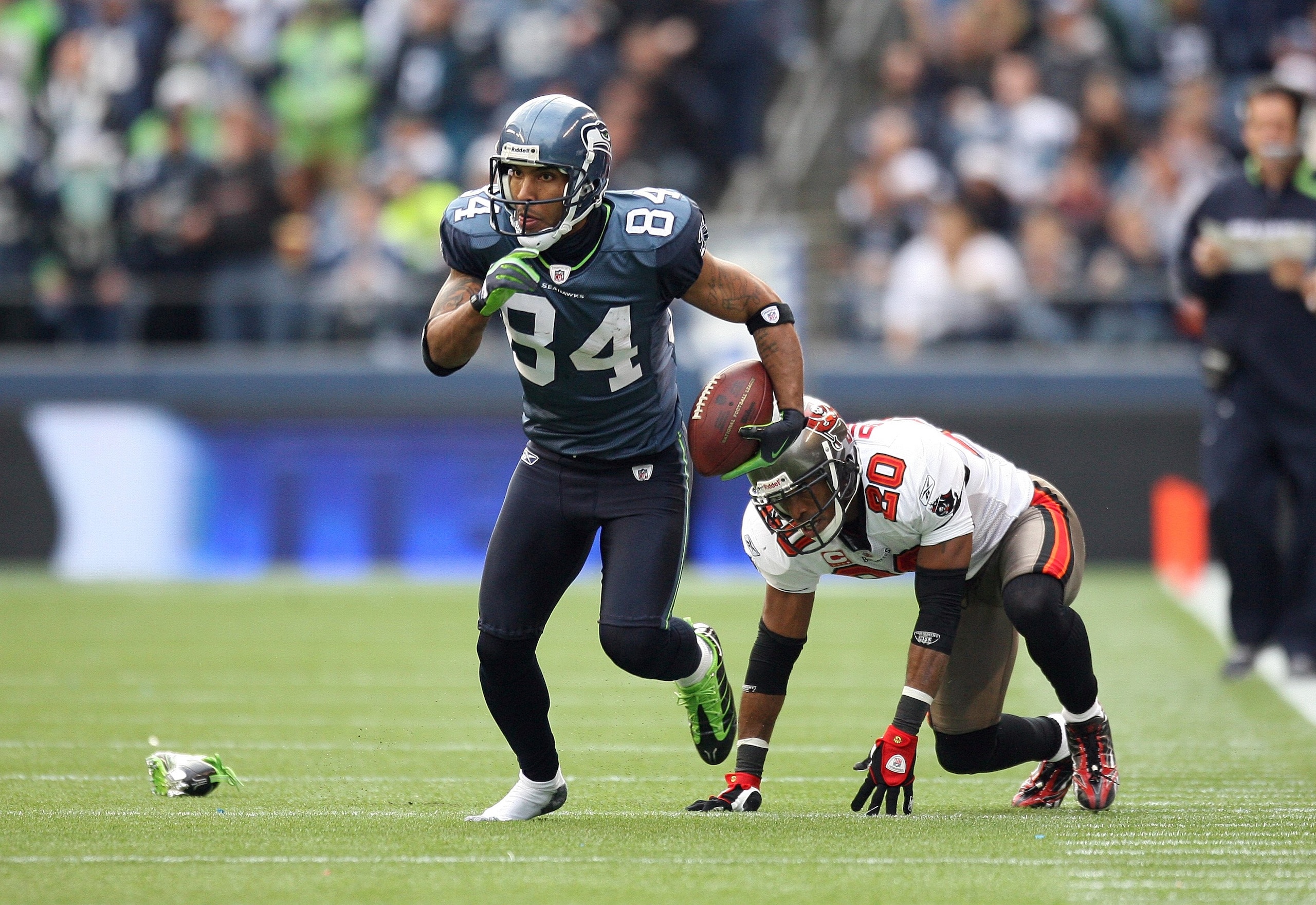 SEATTLE - DECEMBER 20:  T.J. Houshmandzadeh #84 of the Seattle Seahawks runs with the ball for yardage with one shoe on during their game against the Tampa Bay Buccaneers on December 20, 2009 at Qwest Field in Seattle, Washington. The Buccaneers defeated