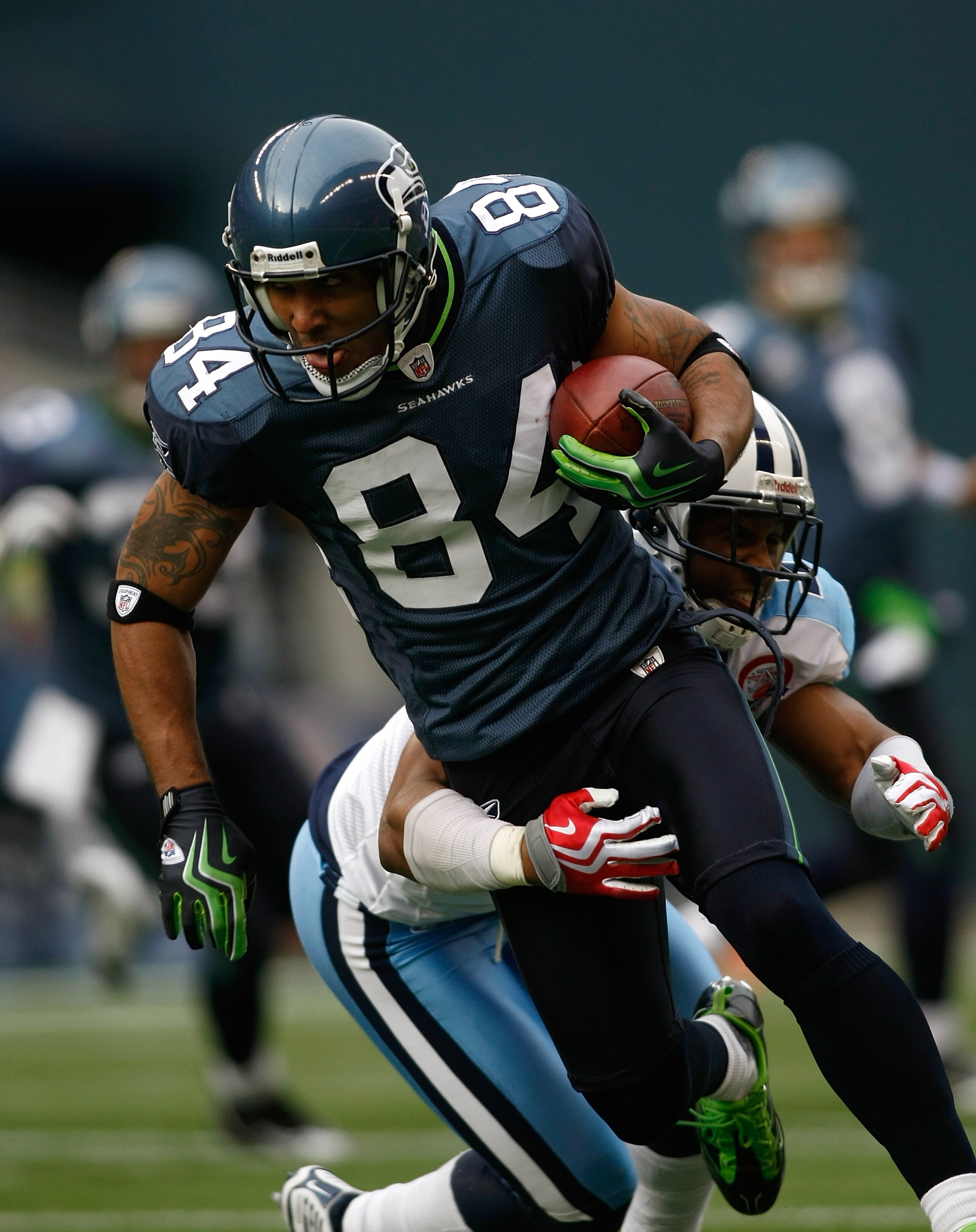 SEATTLE , WA - JANUARY 03:  T.J. Houshmandzadeh #84 of the Seattle Seahawks runs after making a catch against Rod Hood #37 of the Tennessee Titans at Qwest Field on January 3, 2010 in Seattle, Washington.  (Photo by Jonathan Ferrey/Getty Images)