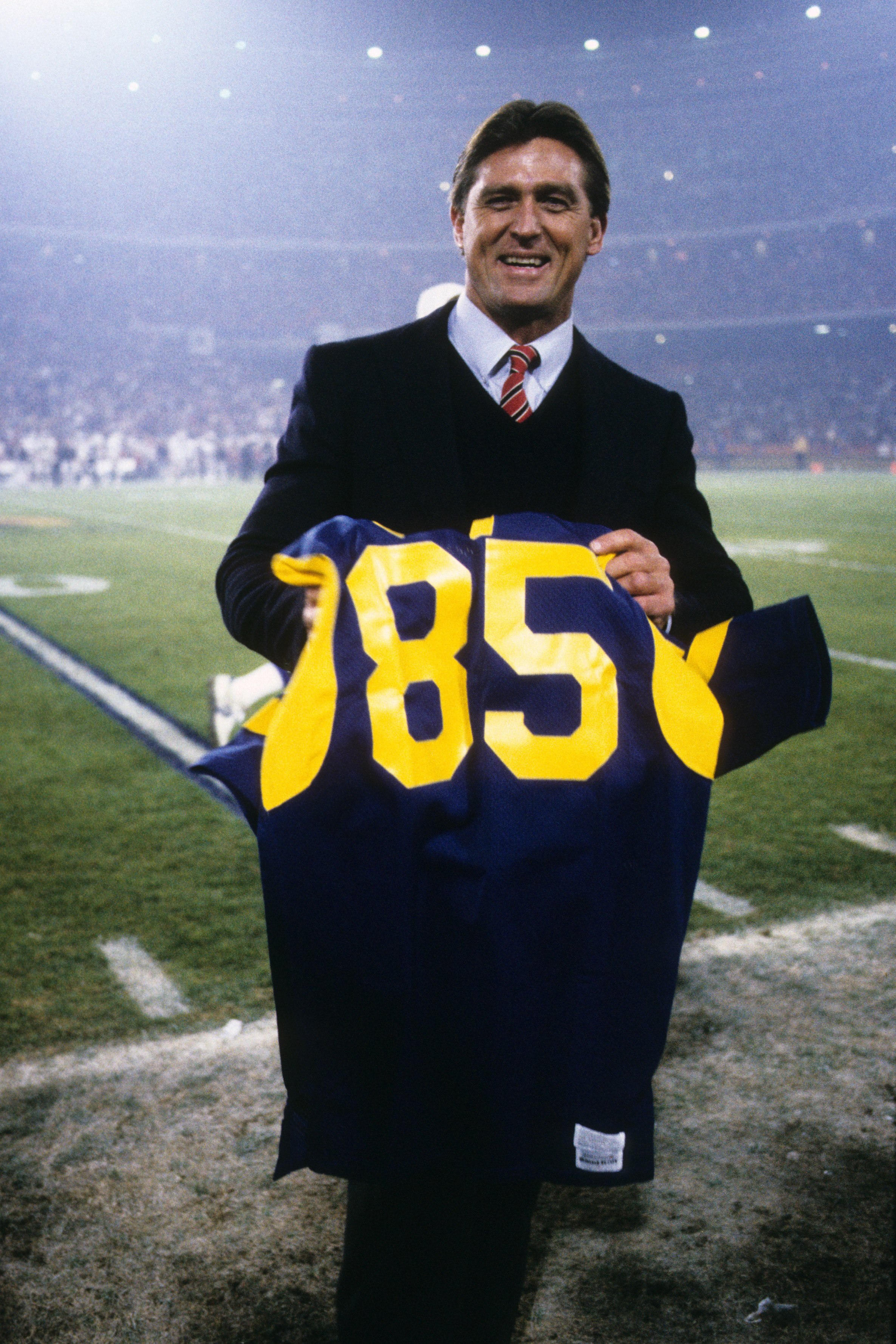 ANAHEIM, CA - DECEMBER 23:  Former Los Angeles Rams great, Jack Youngblood, poses with his officially retired Rams jersey during the game against the Los Angeles Raiders at Anaheim Stadium on December 23, 1985 in Anaheim, California. The Raiders won 16-6.