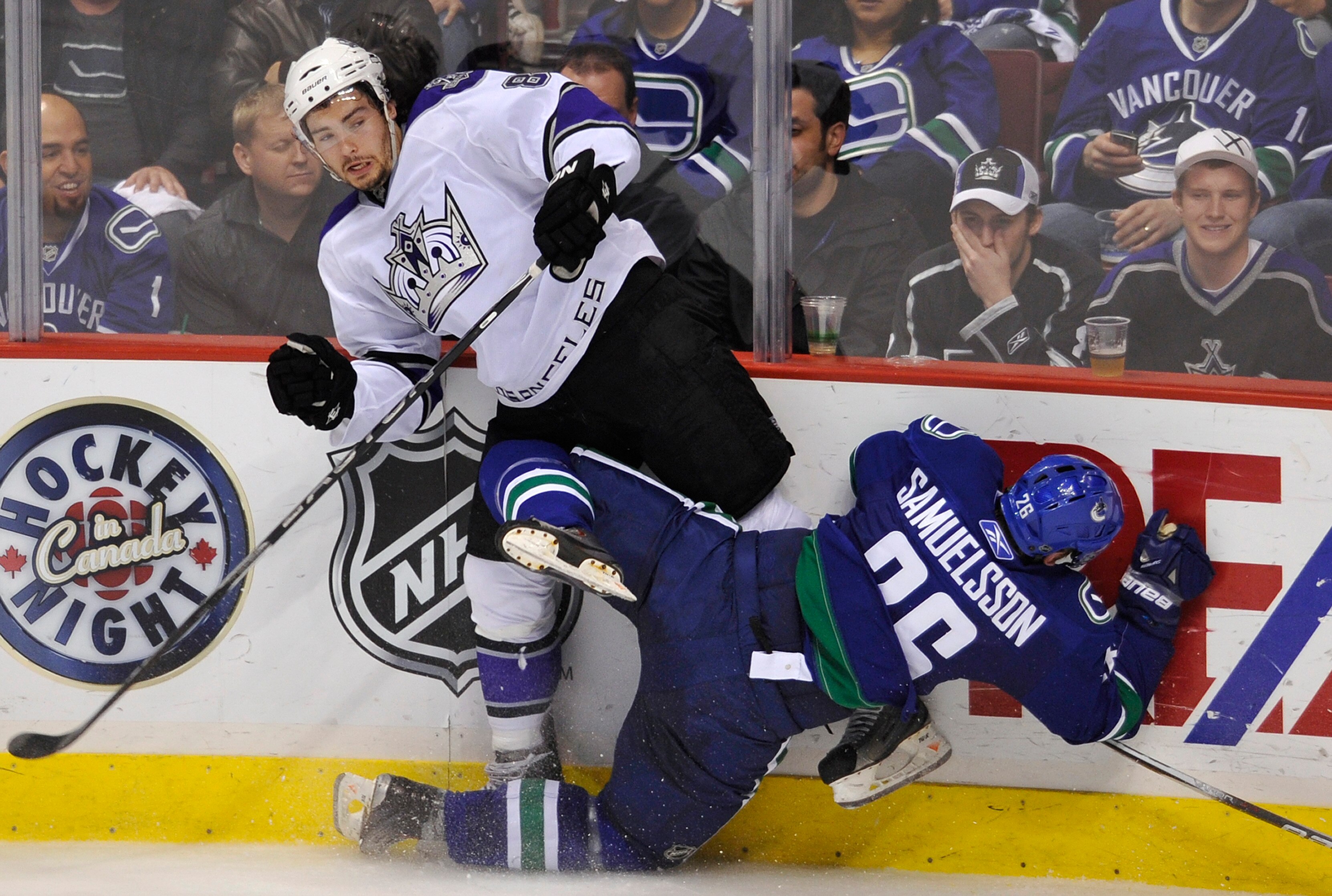 VANCOUVER, CANADA - APRIL 23:  Mikael Samuelsson #26 of the Vancouver Canucks falls to the ice after colliding with Drew Doughty #8 of the Los Angeles Kings during the second period in Game Five of the Western Conference Quarterfinals during the 2010 NHL 