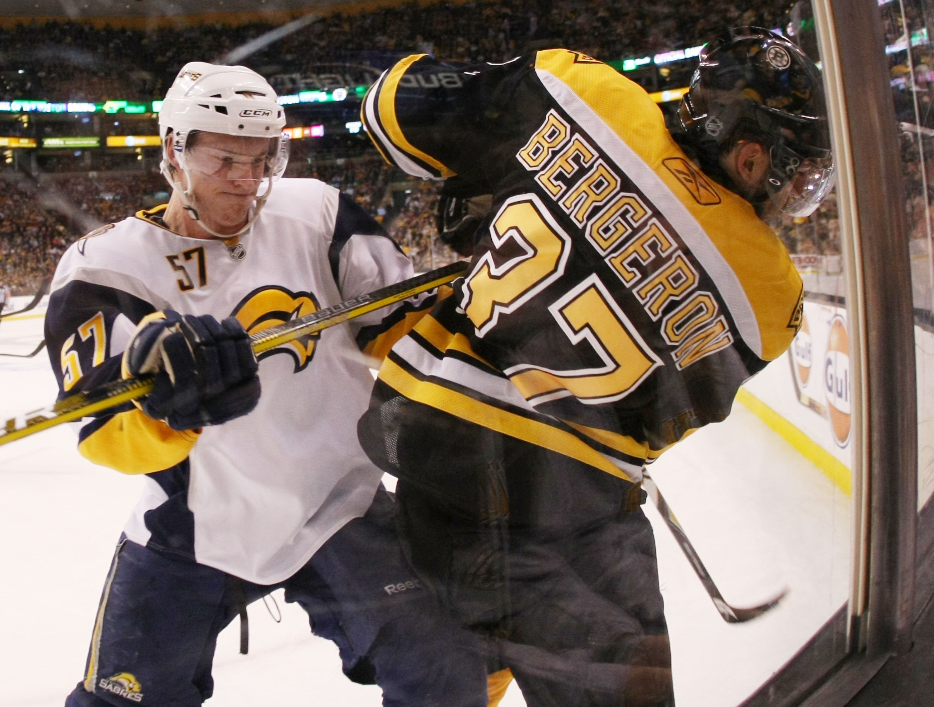 BOSTON - APRIL 19: Tyler Myers #57 of the Buffalo Sabres shoves Patrice Bergeron #37 of the Boston Bruins in Game Three of the Eastern Conference Quarterfinals during the 2010 NHL Stanley Cup Playoffs at TD Garden on April 19, 2010 in Boston, Massachusett