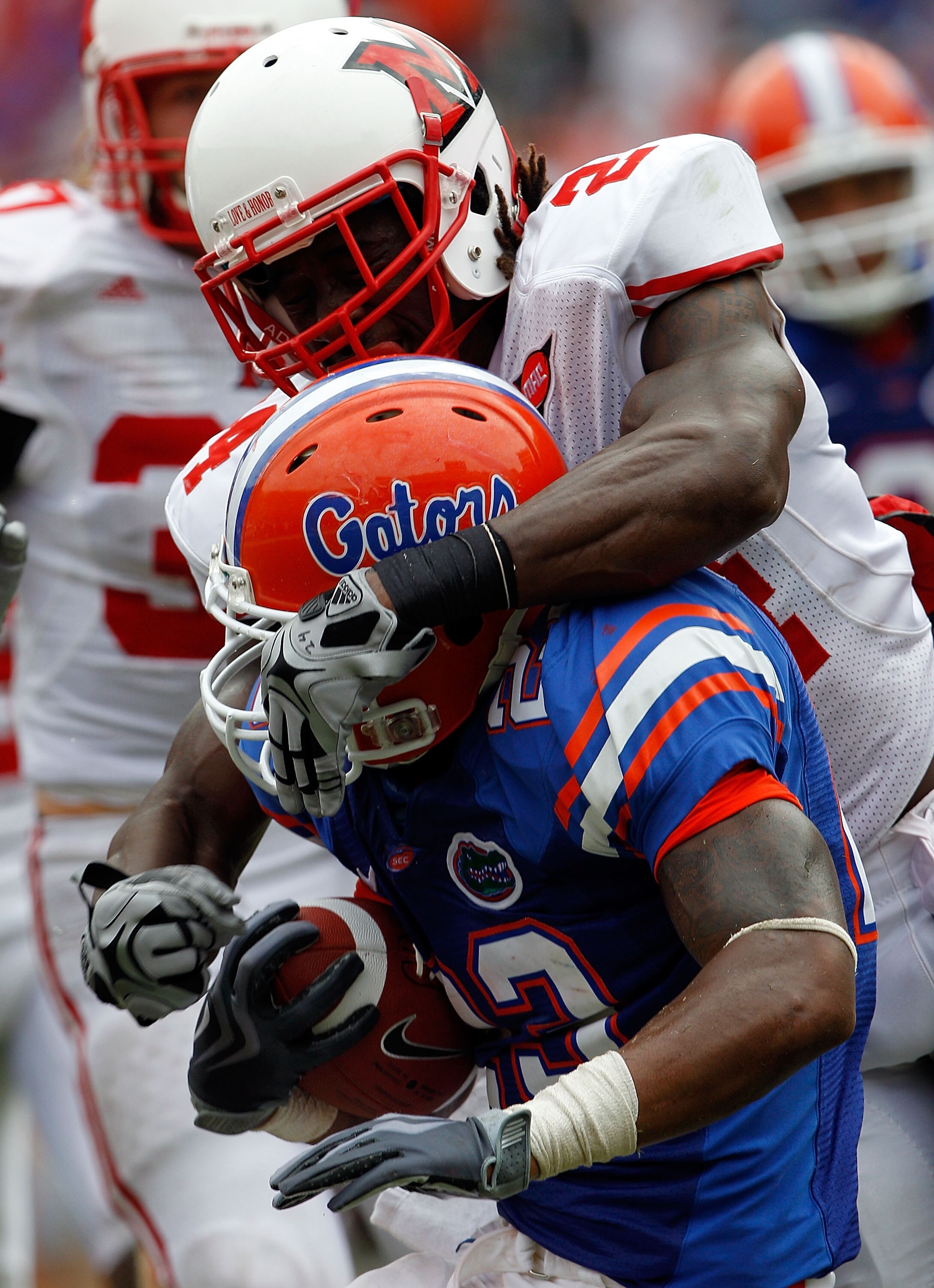 GAINESVILLE, FL - SEPTEMBER 04:  Mike Gillislee #23 of the Florida Gators is tackled by Allen Veazie #2 of the Miami University RedHawks at Ben Hill Griffin Stadium on September 4, 2010 in Gainesville, Florida.  (Photo by Sam Greenwood/Getty Images)