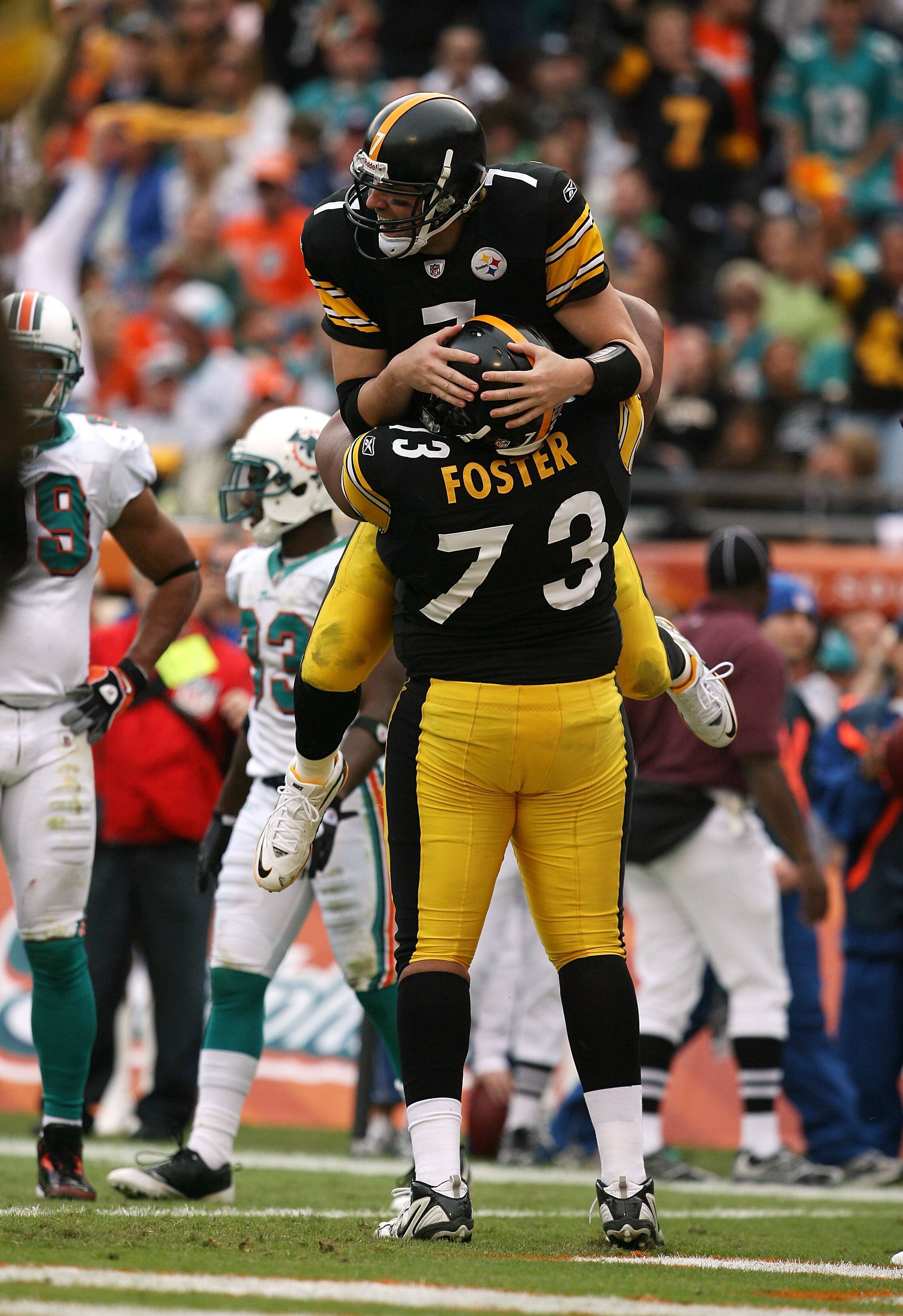MIAMI - JANUARY 03:  Quarterback Ben Roethlisberger #7 of the Pittsburgh Steelers is lifted into the air by offensive linemen Ramon Foster #73 after Roethlisberger's touchdown pass to tight end Heath Miller #83 in the third quarter against the Miami Dolph