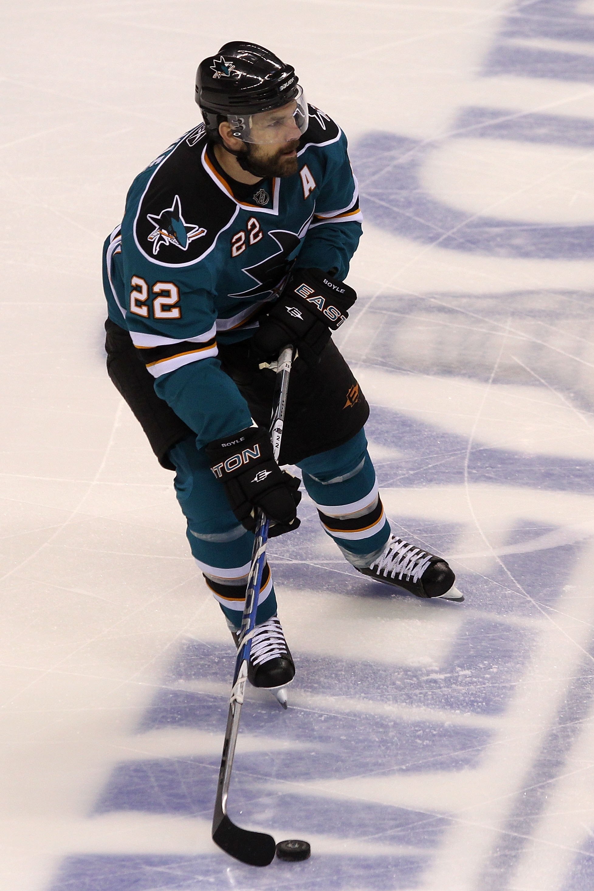 SAN JOSE, CA - MAY 18:  Dan Boyle #22 of the San Jose Sharks moves the puck while taking on the Chicago Blackhawks in Game Two of the Western Conference Finals during the 2010 NHL Stanley Cup Playoffs at HP Pavilion on May 18, 2010 in San Jose, California