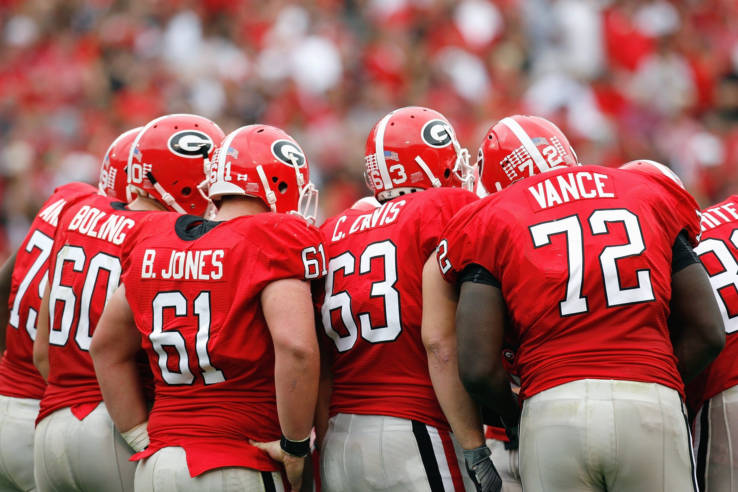 ATHENS, GA - OCTOBER 11:  Ben Jones #61, Chris Davis #63 and Vince Vance #72 of the Georgia Bulldogs huddle during the game against the Tennessee Volunteers at Sanford Stadium on October 11, 2008 in Athens, Georgia.  (Photo by Kevin C. Cox/Getty Images)