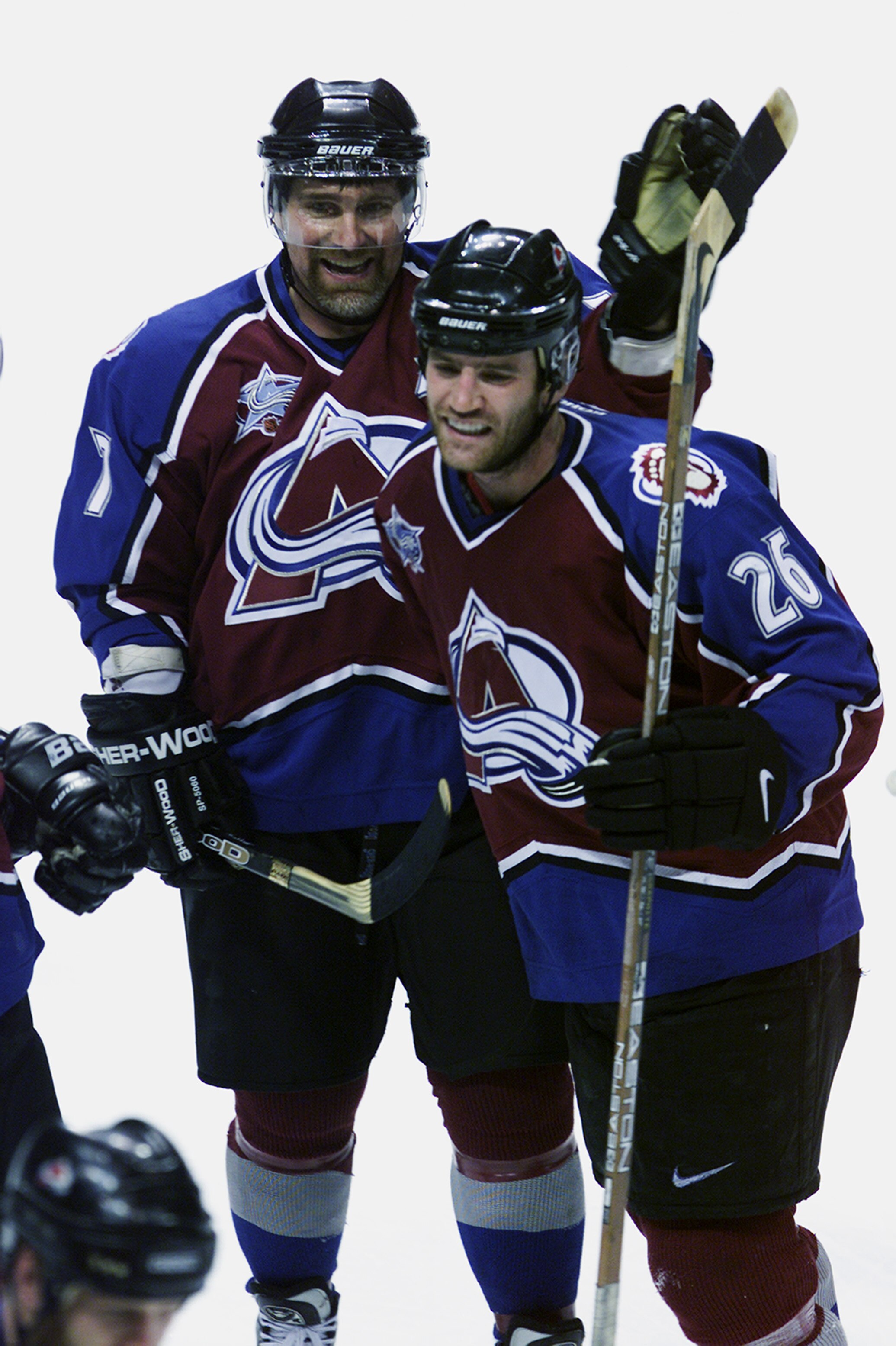 ST. LOUIS - MAY 18:  Stephane Yelle #26 of the Colorado Avalanche is congratulated by Ray Bourque #77 after Yelle scored the winning overtime goal against the St. Louis Blues in Game four of Western Conference Finals during the 2001 Stanley Cup Playoffs o