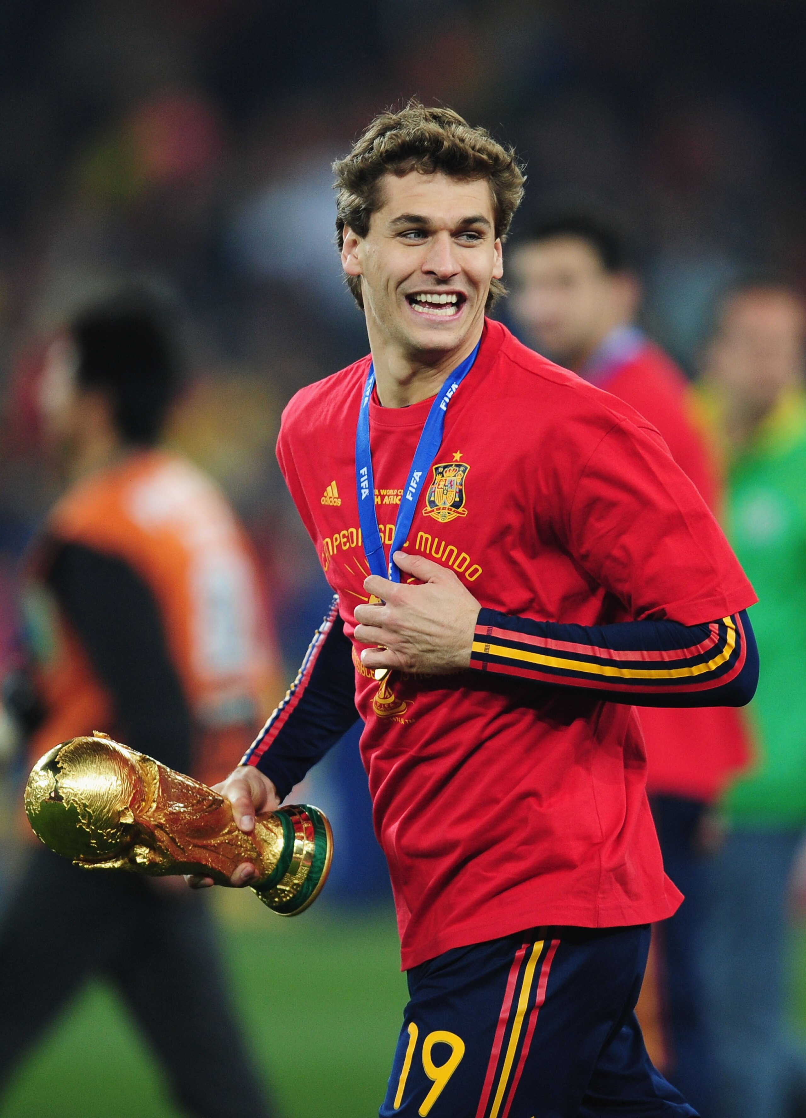 JOHANNESBURG, SOUTH AFRICA - JULY 11:  Fernando Llorente of Spain carries the World Cup trophy as the Spain team celebrate victory following the 2010 FIFA World Cup South Africa Final match between Netherlands and Spain at Soccer City Stadium on July 11,