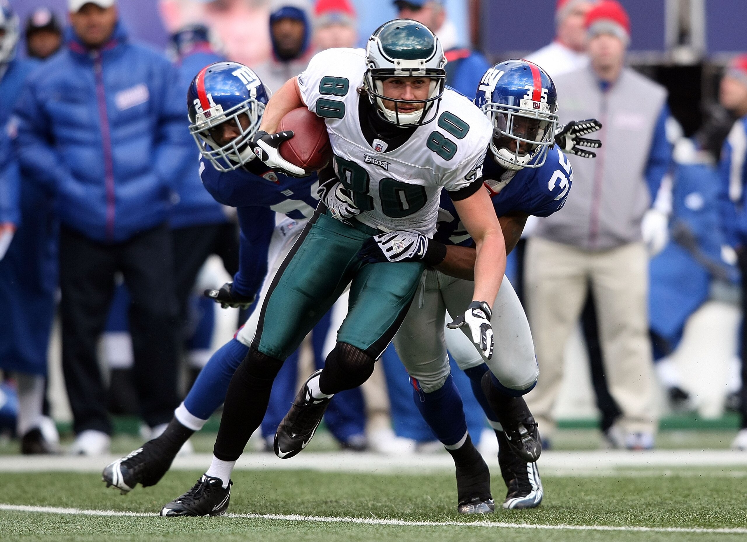 EAST RUTHERFORD, NJ - DECEMBER 07: Kevin Curtis #80 of the Philadelphia Eagles is tackled against the New York Giants at Giants Stadium on December 7, 2008 in East Rutherford, New Jersey.  (Photo by Nick Laham/Getty Images)