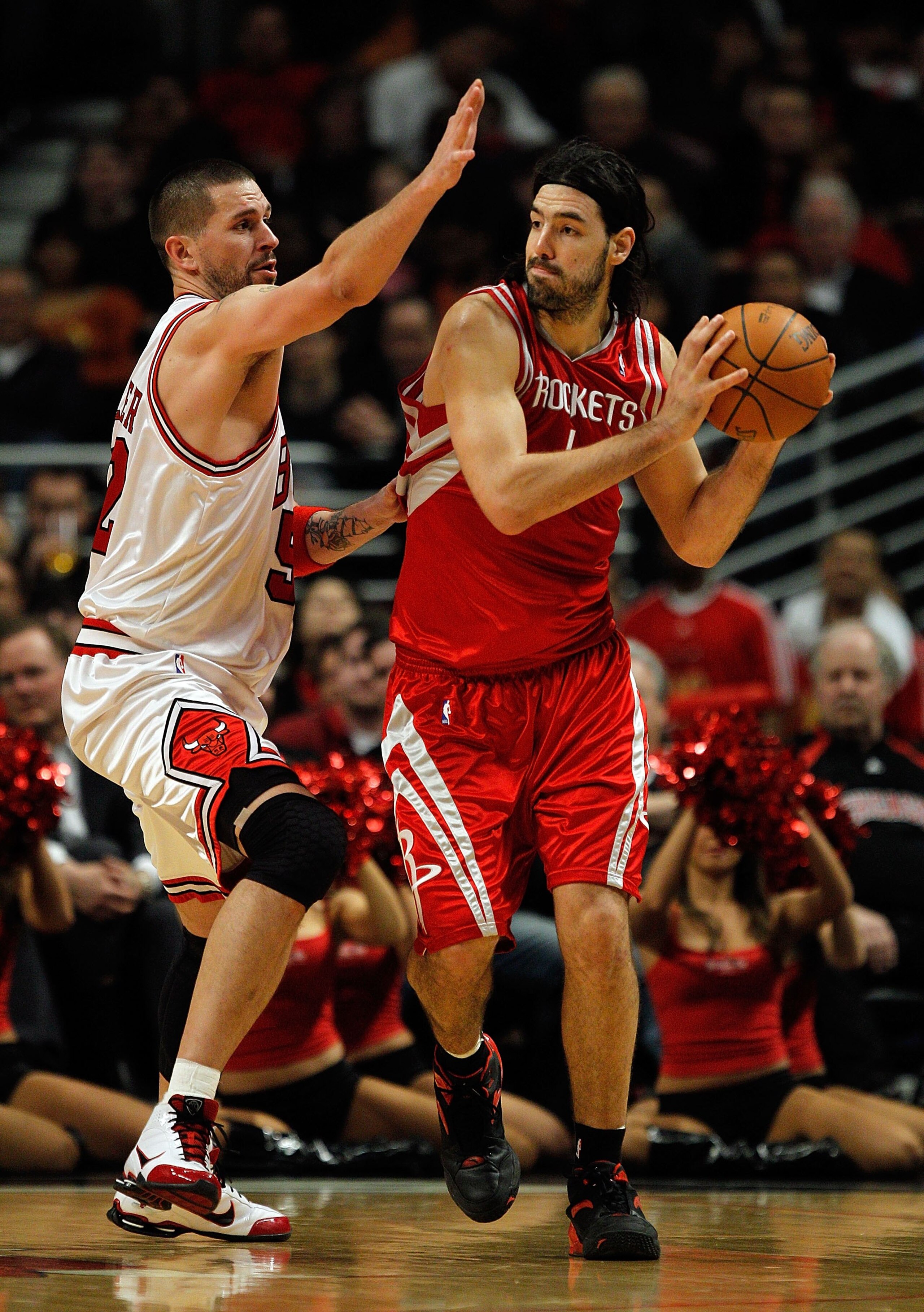 CHICAGO - MARCH 22: Luis Scola #4 of the Houston Rockets looks to pass under pressure from Brad Miller #52 of the Chicago Bulls at the United Center on March 22, 2010 in Chicago, Illinois. The Bulls defeated the Rockets 98-88. NOTE TO USER: User expressly CHICAGO - MARCH 22: Luis Scola #4 of the Houston Rockets looks to pass under pressure from Brad Miller #52 of the Chicago Bulls at the United Center on March 22, 2010 in Chicago, Illinois. The Bulls defeated the Rockets 98-88. NOTE TO USER: User expressly