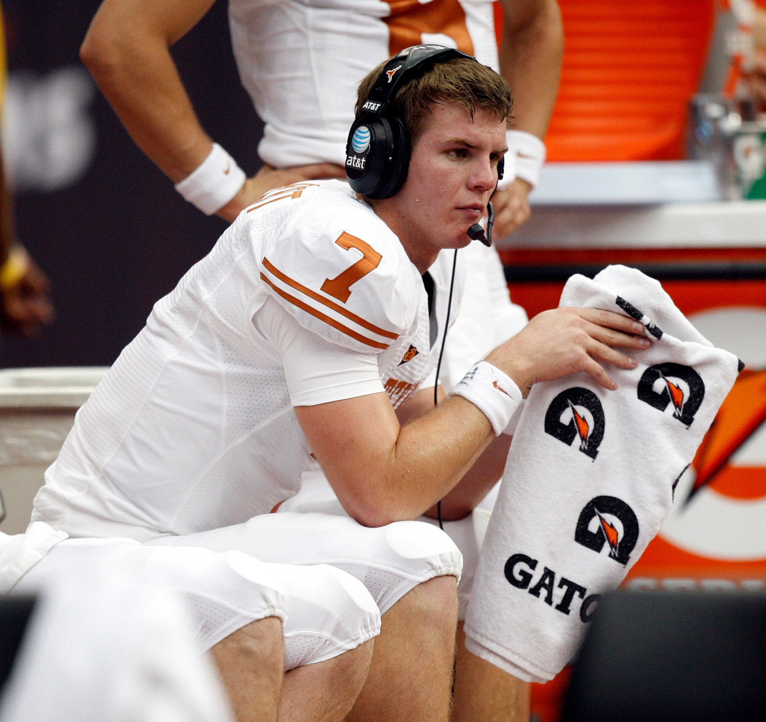 HOUSTON - SEPTEMBER 04:  Quarterback Garrett Gilbert #7 of the Texas Longhorns talks with coaches in the press box during a game against the Rice Owls at Reliant Stadium on September 4, 2010 in Houston, Texas. Texas beat Rice 34-17.  (Photo by Bob Levey/G