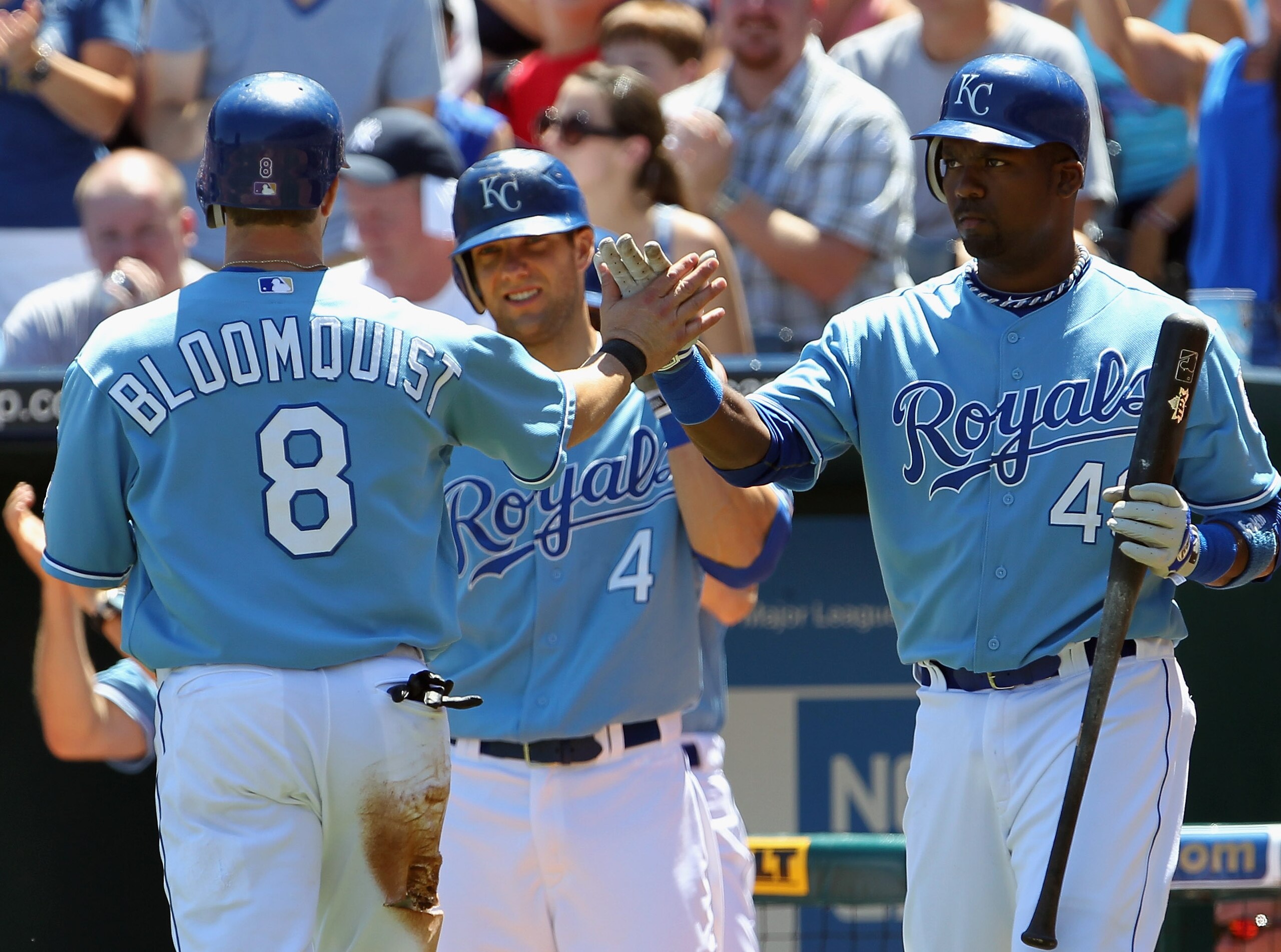 KANSAS CITY, MO - AUGUST 15:  Willie Bloomquist #8 of the Kansas City Royals is congratulated by Alex Gordon #4 and Wilson Betemit #46 after scoring the game's only run during the first inning of the game against the New York Yankees on August 15, 2010 at