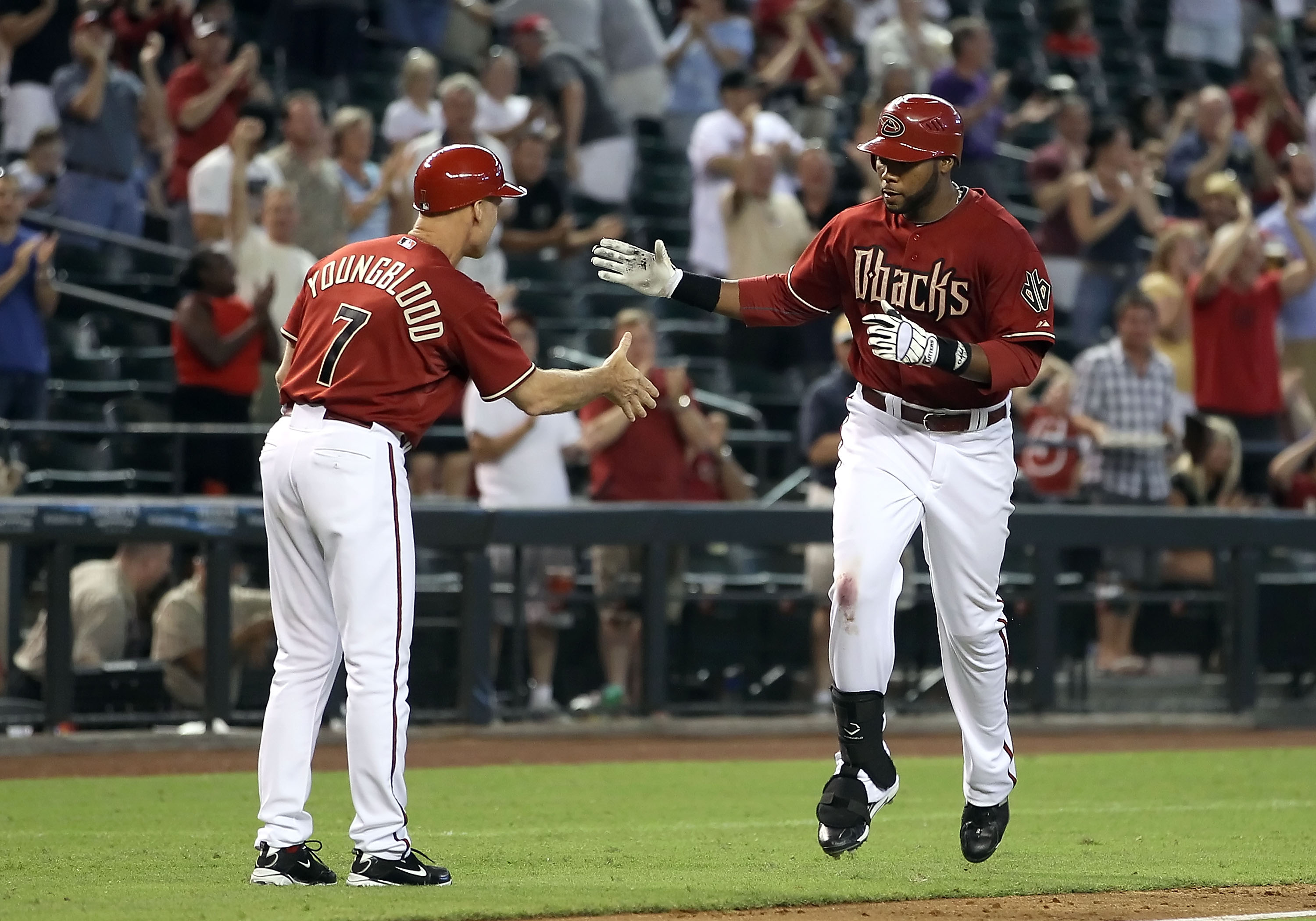 PHOENIX - SEPTEMBER 01:  Brandon Allen #29 of the Arizona Diamondbacks high fives third base coach Joel Youngblood after hitting a grand slam against the San Diego Padres during the seventh inning of the Major League Baseball game at Chase Field on Septem