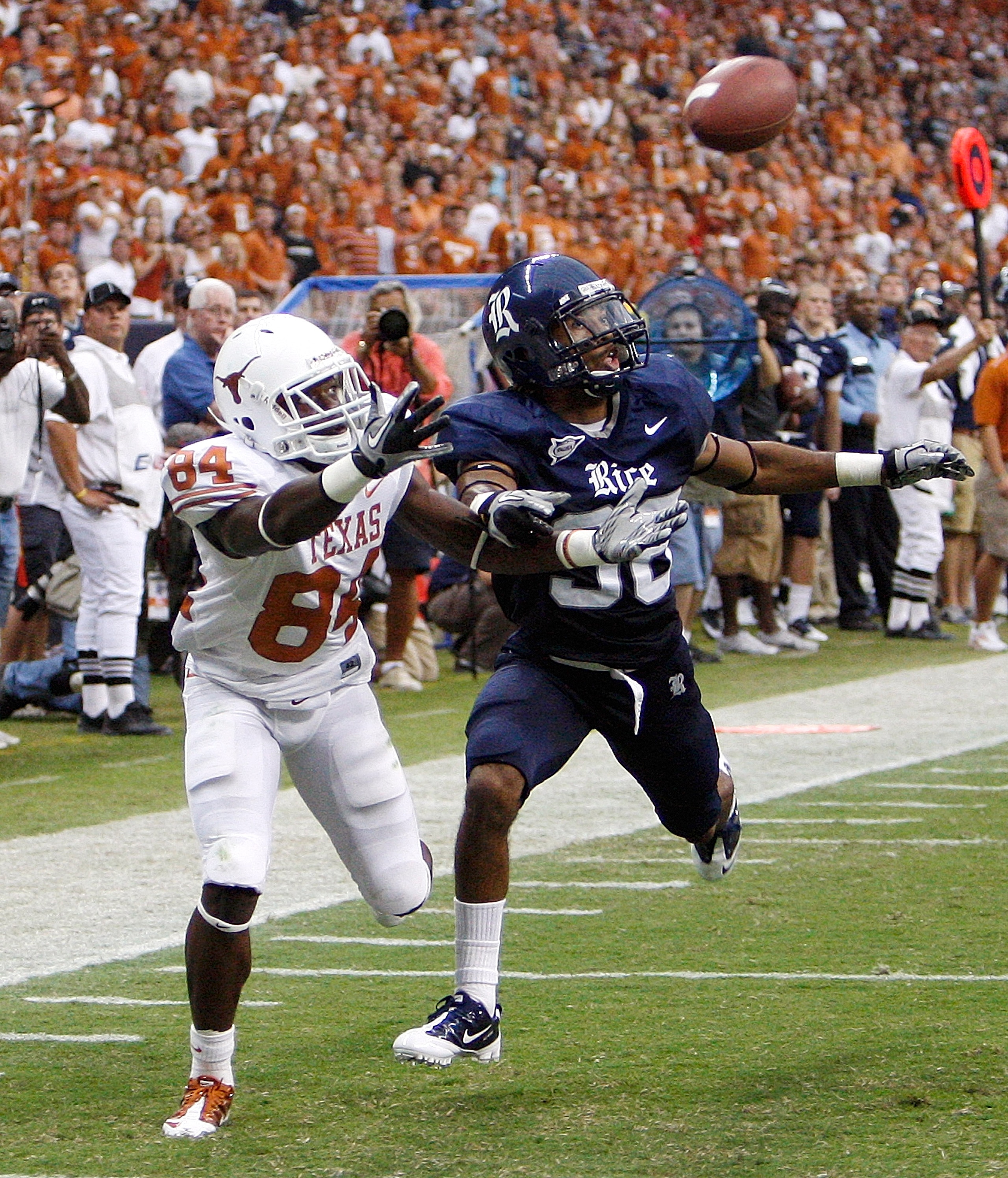 HOUSTON - SEPTEMBER 04:  Wide receiver Marquise Goodwin #84 of the Texas Longhorns can't reach the pass as he is defended by cornerback Chris Jammer #38 at Reliant Stadium on September 4, 2010 in Houston, Texas. Texas beat Rice 34-17. (Photo by Bob Levey/