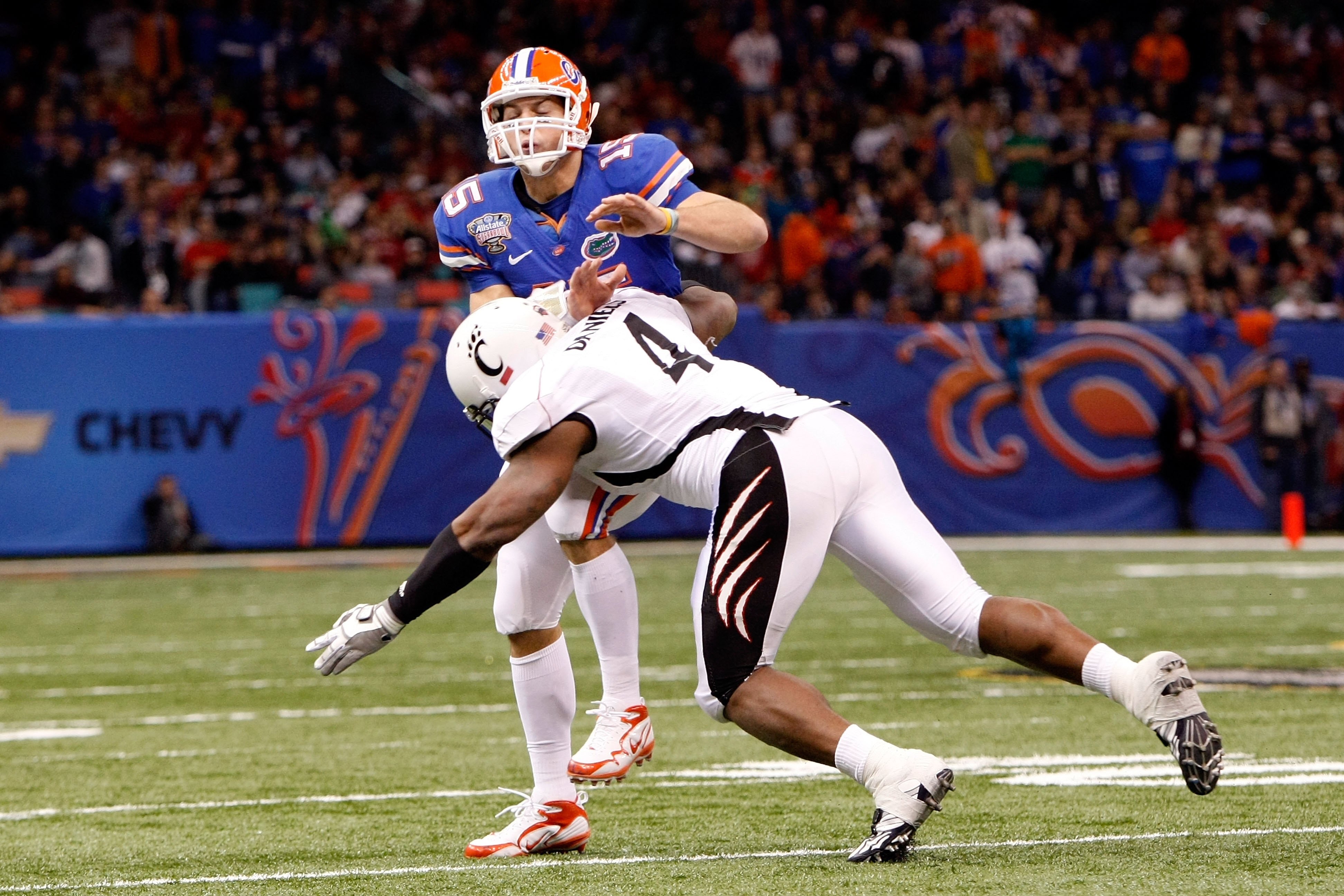 NEW ORLEANS - JANUARY 01:  Alex Daniels #4 of the Cincinnati Bearcats tackels quarterback Tim Tebow #15 of the Florida Gators during the Allstate Sugar Bowl at the Louisana Superdome on January 1, 2010 in New Orleans, Louisiana.  (Photo by Kevin C. Cox/Ge