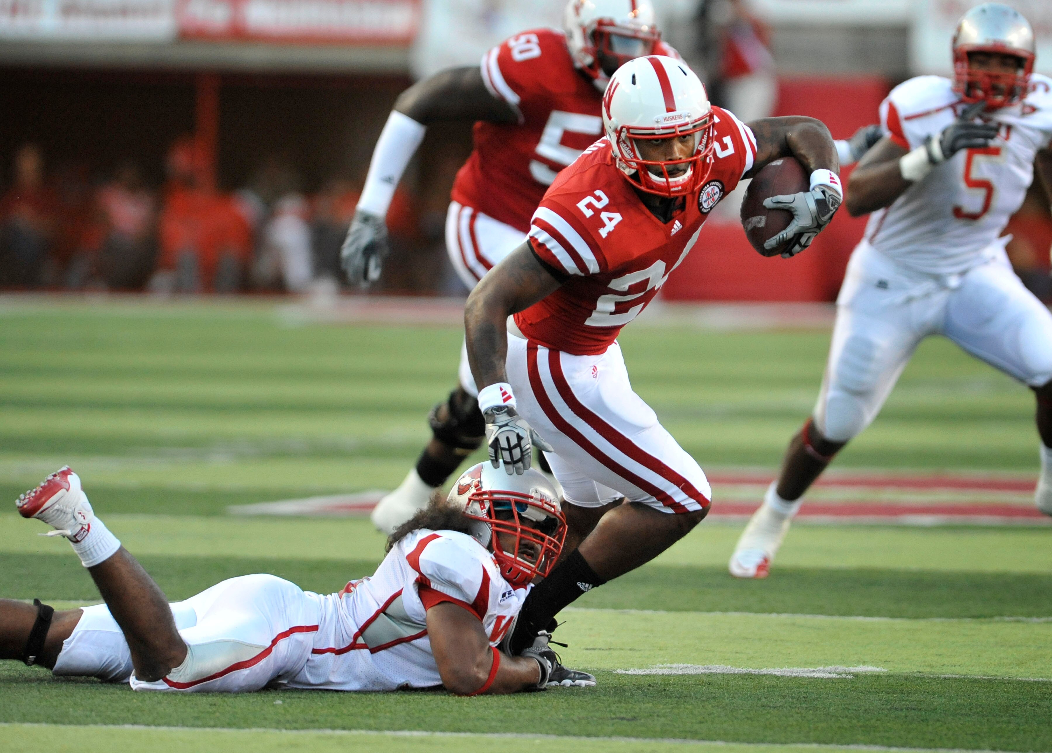 LINCOLN, NE - SEPTEMBER 04:  Orlando Misaalefua #31 of the Western Kentucky Hilltoppers tries to bring down Niles Paul #24 of the Nebraska Cornhuskers during first half action of their game at Memorial Stadium on September 4, 2010 in Lincoln, Nebraska.  N