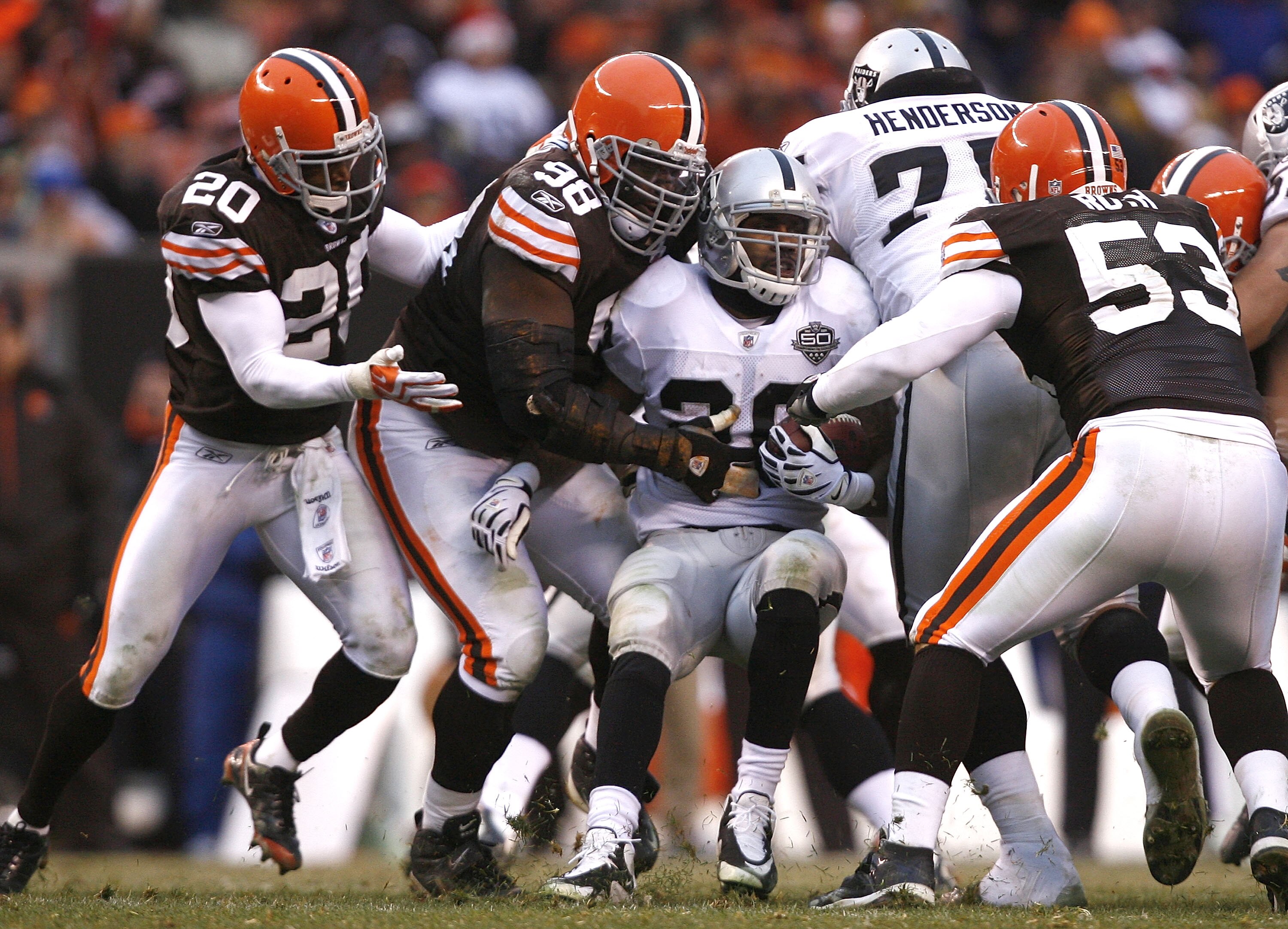 CLEVELAND - DECEMBER 27:  Mike Adams #20, Robaire Smith #98 and Matt Roth #53 of the Cleveland Browns tackle Darren McFadden #20 of the Oakland Raiders at Cleveland Browns Stadium on December 27, 2009 in Cleveland, Ohio.  (Photo by Matt Sullivan/Getty Ima