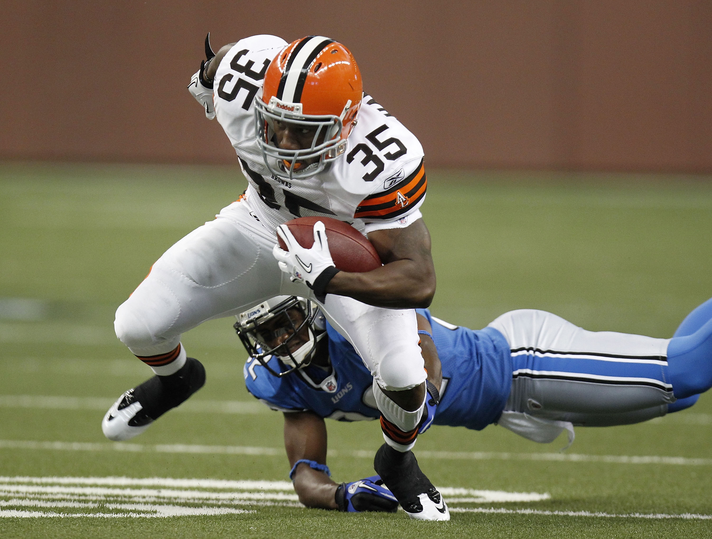 DETROIT - AUGUST 28: Jerome Harrison #35 of the Cleveland Browns tries to escape the tackle of Dre Bly #32 of the Detroit Lions during preseason game on August 28, 2010 at Ford Field in Detroit, Michigan.  (Photo by Gregory Shamus/Getty Images)