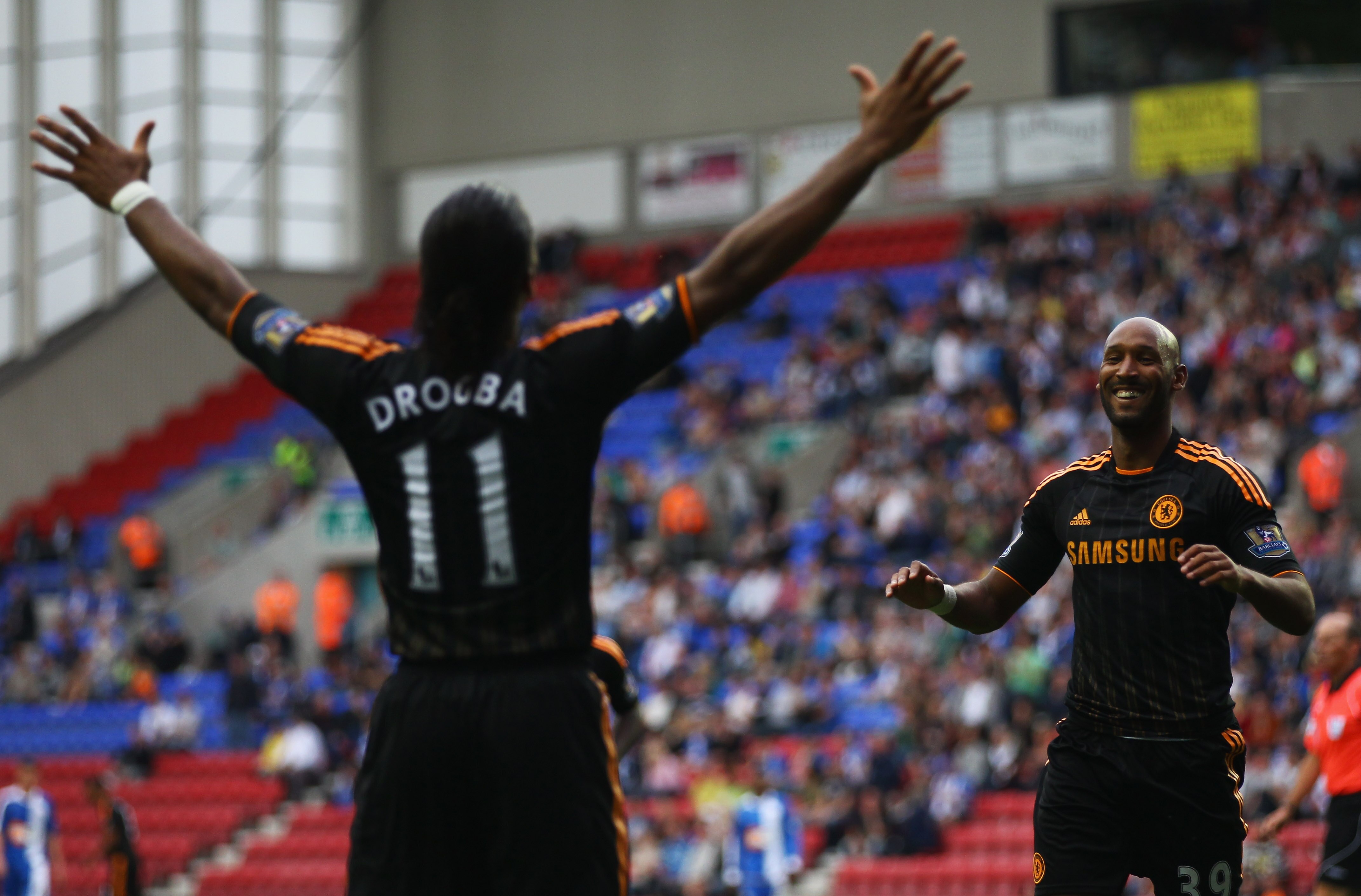 WIGAN, ENGLAND - AUGUST 21:  Nicolas Anelka of Chelsea celebrates with Didier Drogba (11) as he scores their third goal during the Barclays Premier League match between Wigan Athletic and Chelsea at DW Stadium on August 21, 2010 in Wigan, England.  (Photo