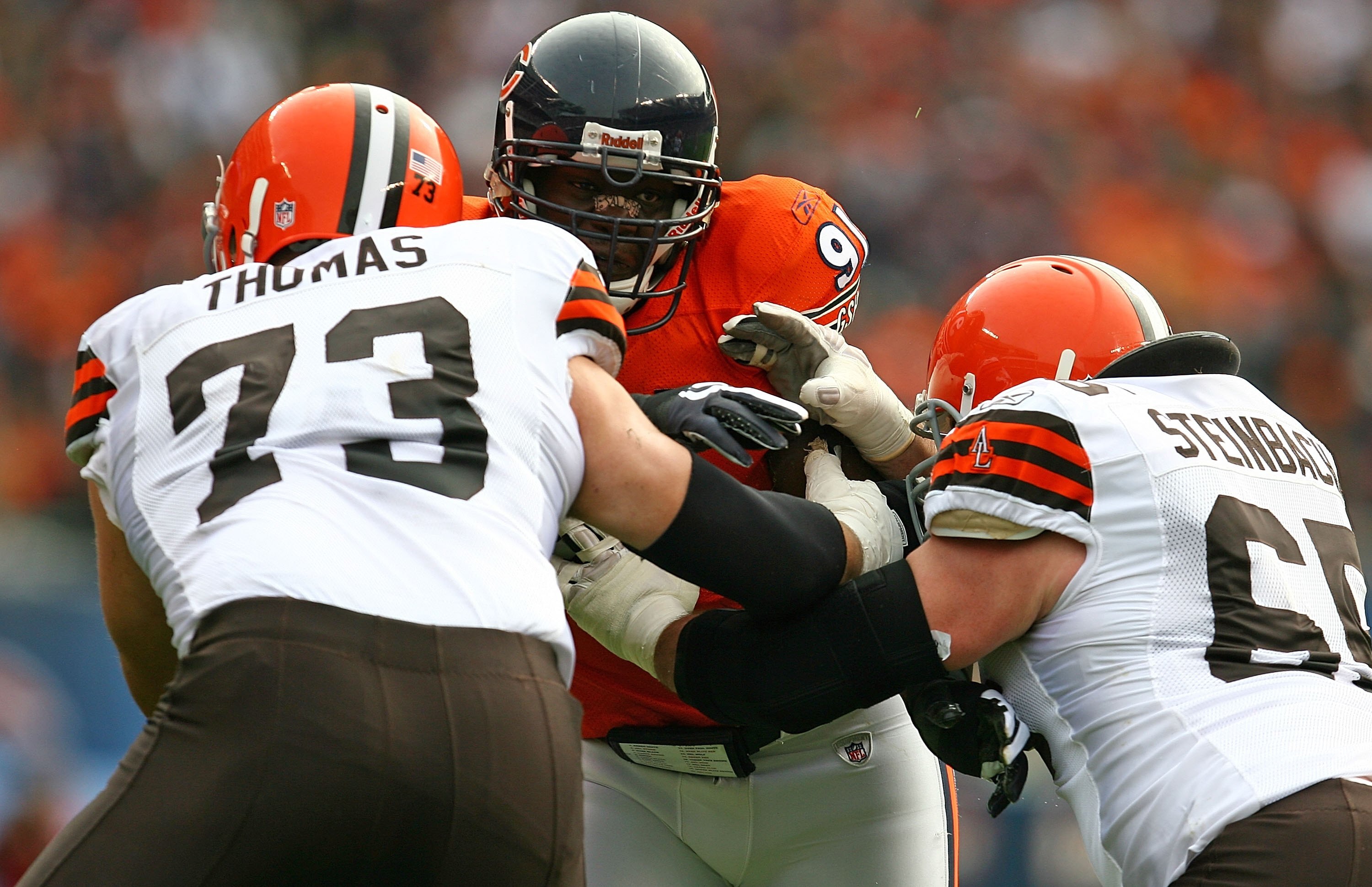 CHICAGO - NOVEMBER 01: Tommie Harris #91 of the Chicago Bears is double-teamed blocked by Joe Thomas #73 and Eric Steinbach #65 of the Cleveland Browns at Soldier Field on November 1, 2009 in Chicago, Illinois. The Bears defeated the Browns 30-6.  (Photo