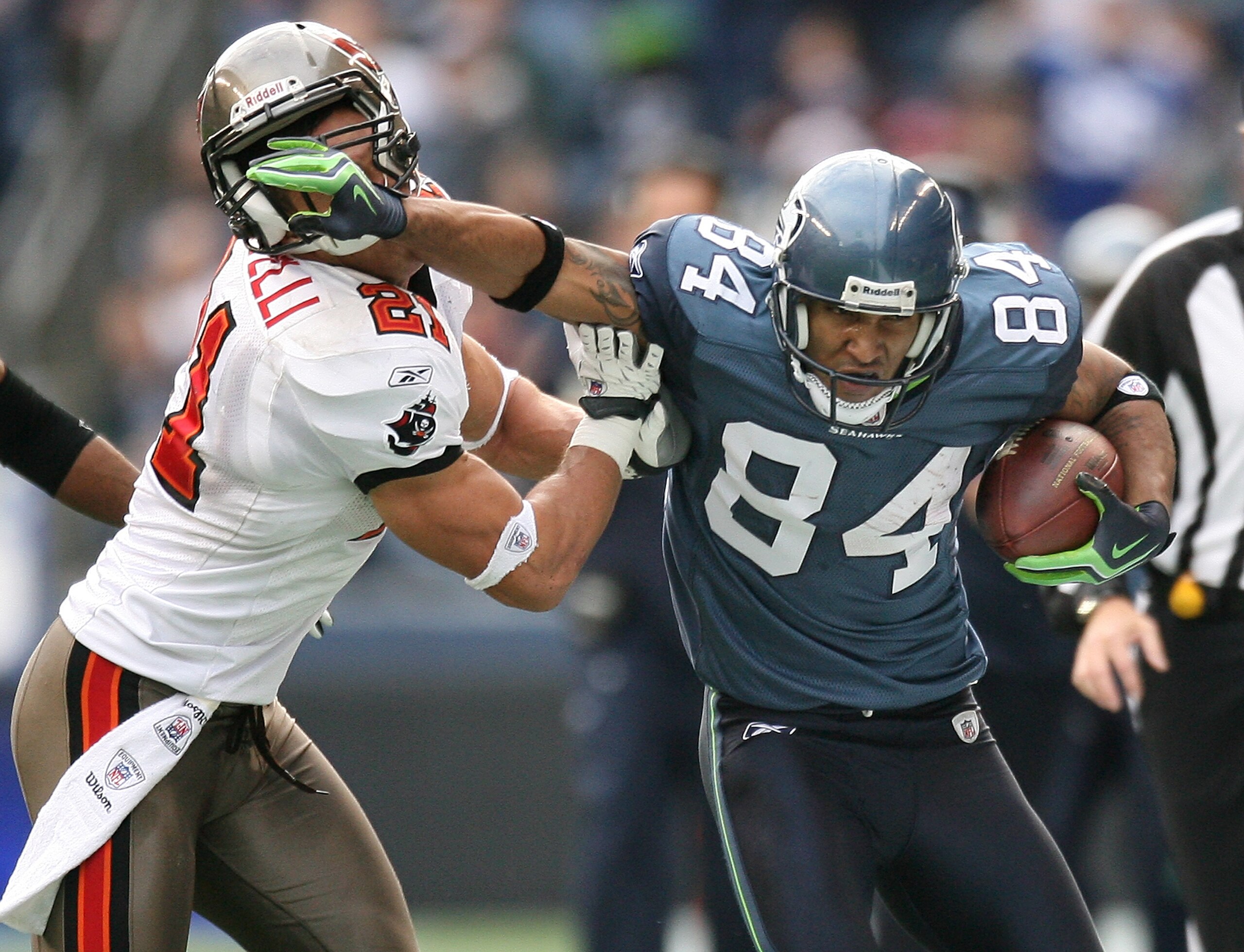 SEATTLE - DECEMBER 20:  Wide receiver T.J. Houshmandzadeh #84 of the Seattle Seahawks straight arms Sabby Piscitelli #21 of the Tampa Bay Buccaneers on December 20, 2009 at Qwest Field in Seattle, Washington. The Buccaneers defeated the Seahawks 24-7.(Pho
