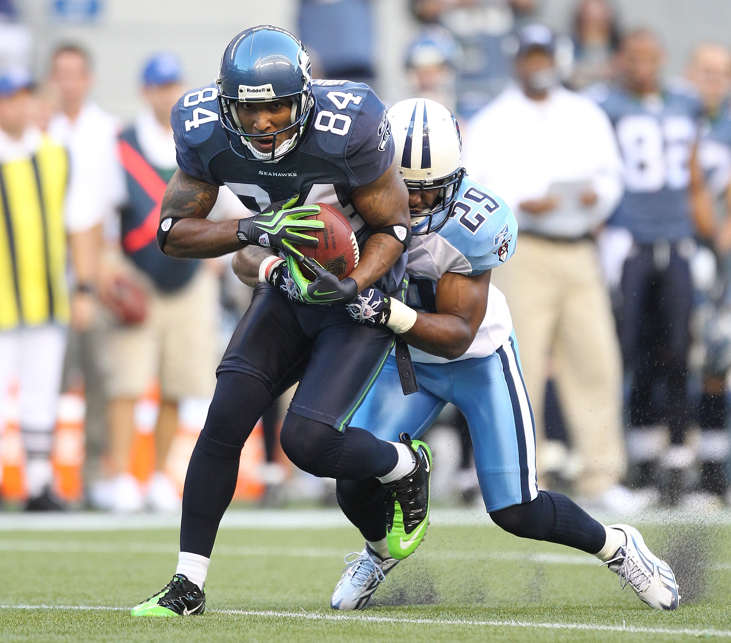SEATTLE - AUGUST 14:  Wide receiver T.J. Houshmandzadeh #84 of the Seattle Seahawks makes a catch against Ryan Mouton #29 during the preseason game against the Tennessee Titans at Qwest Field on August 14, 2010 in Seattle, Washington. (Photo by Otto Greul