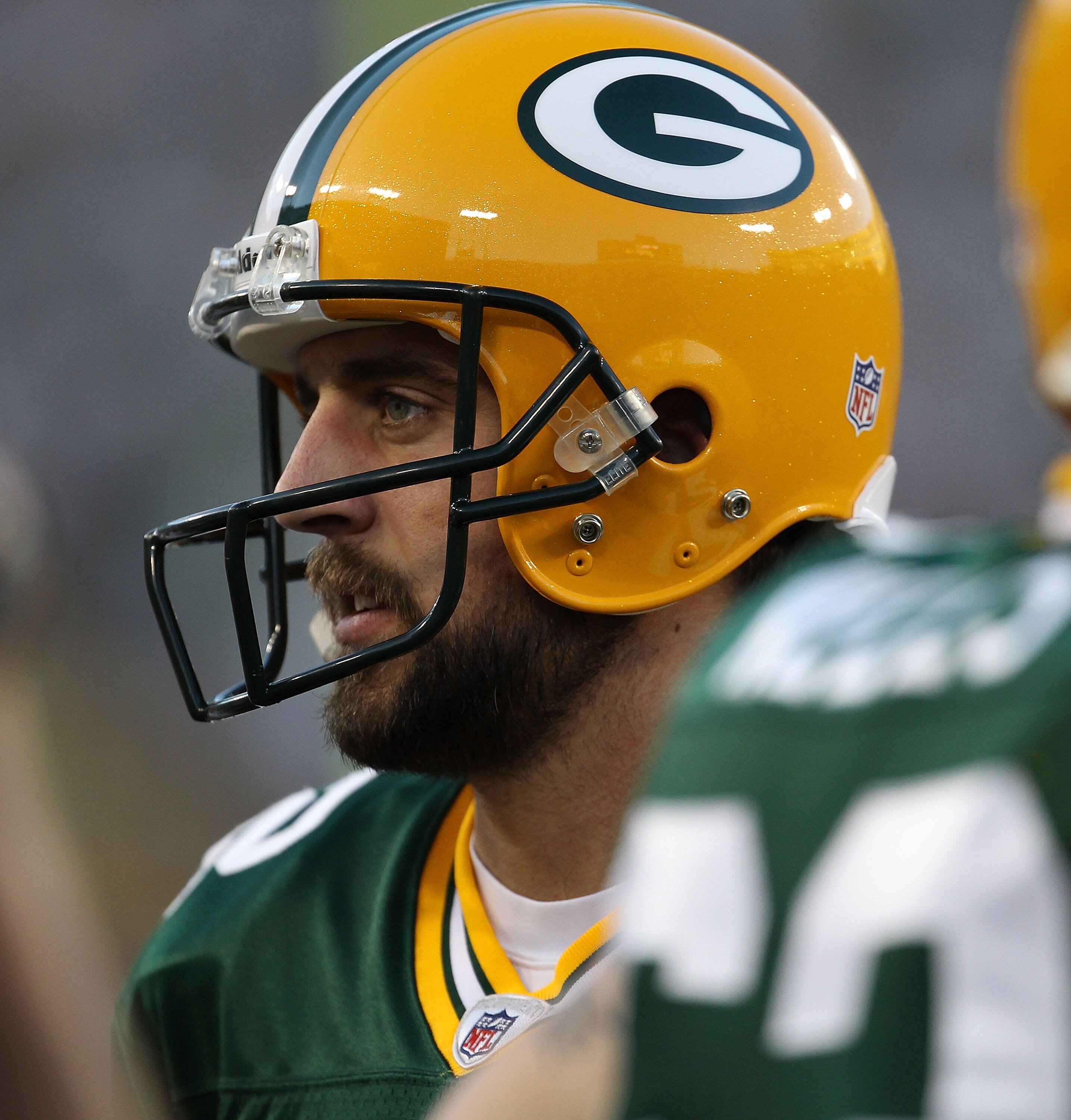 GREEN BAY, WI - AUGUST 26: Aaron Rodgers #12 of the Green Bay Packers talks with teammates before entering the field against the Indianapolis Colts during a preseason game at Lambeau Field on August 26, 2010 in Green Bay, Wisconsin. The Packers defeated t