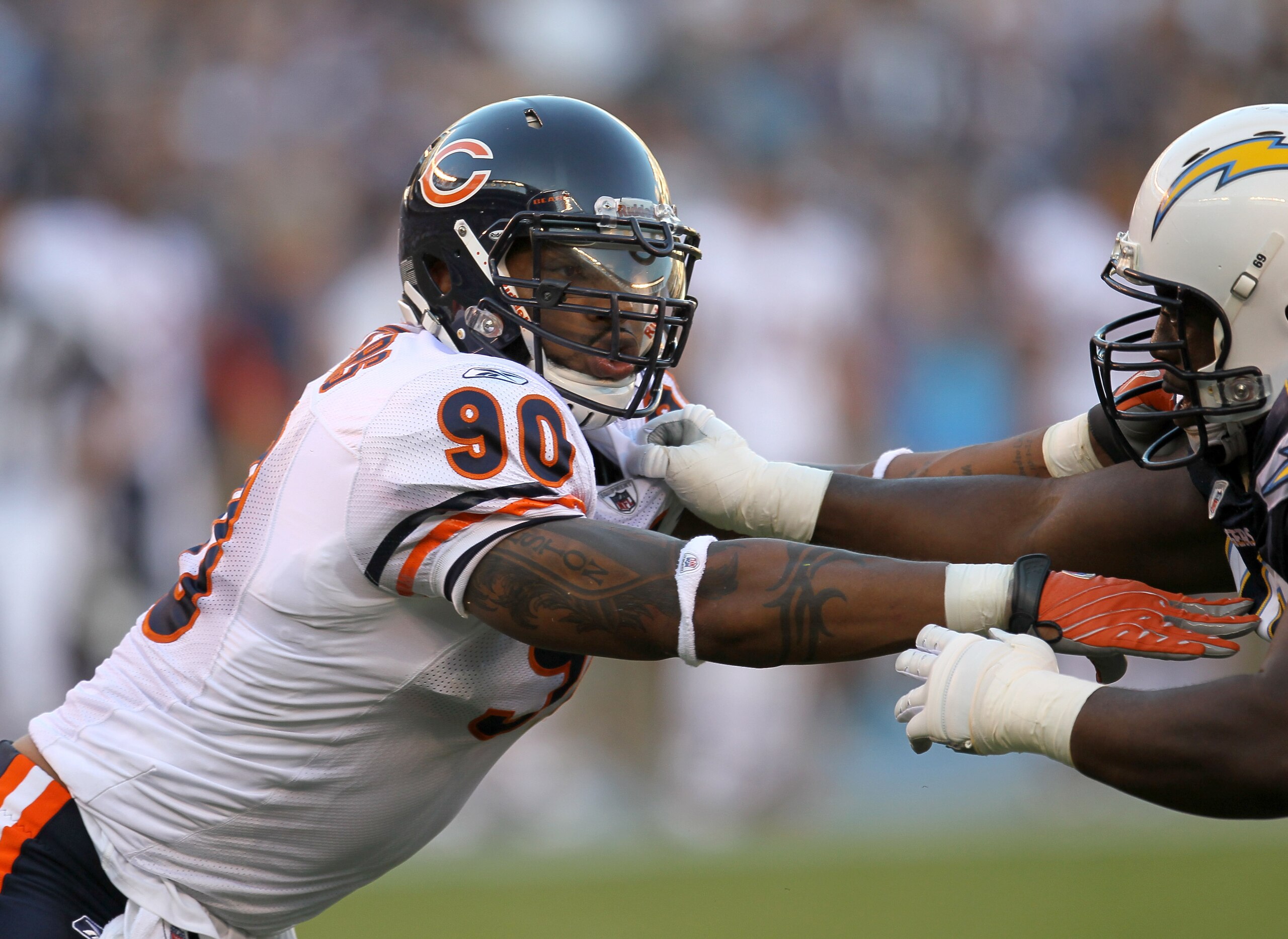 SAN DIEGO - AUGUST 14:  Defensive end Julius Peppers #90 of the Chicago Bears battles offensive guard Tyronne Green #69 of the San Diego Chargers on August 14, 2010 at Qualcomm Stadium in San Diego, California.  (Photo by Stephen Dunn/Getty Images)