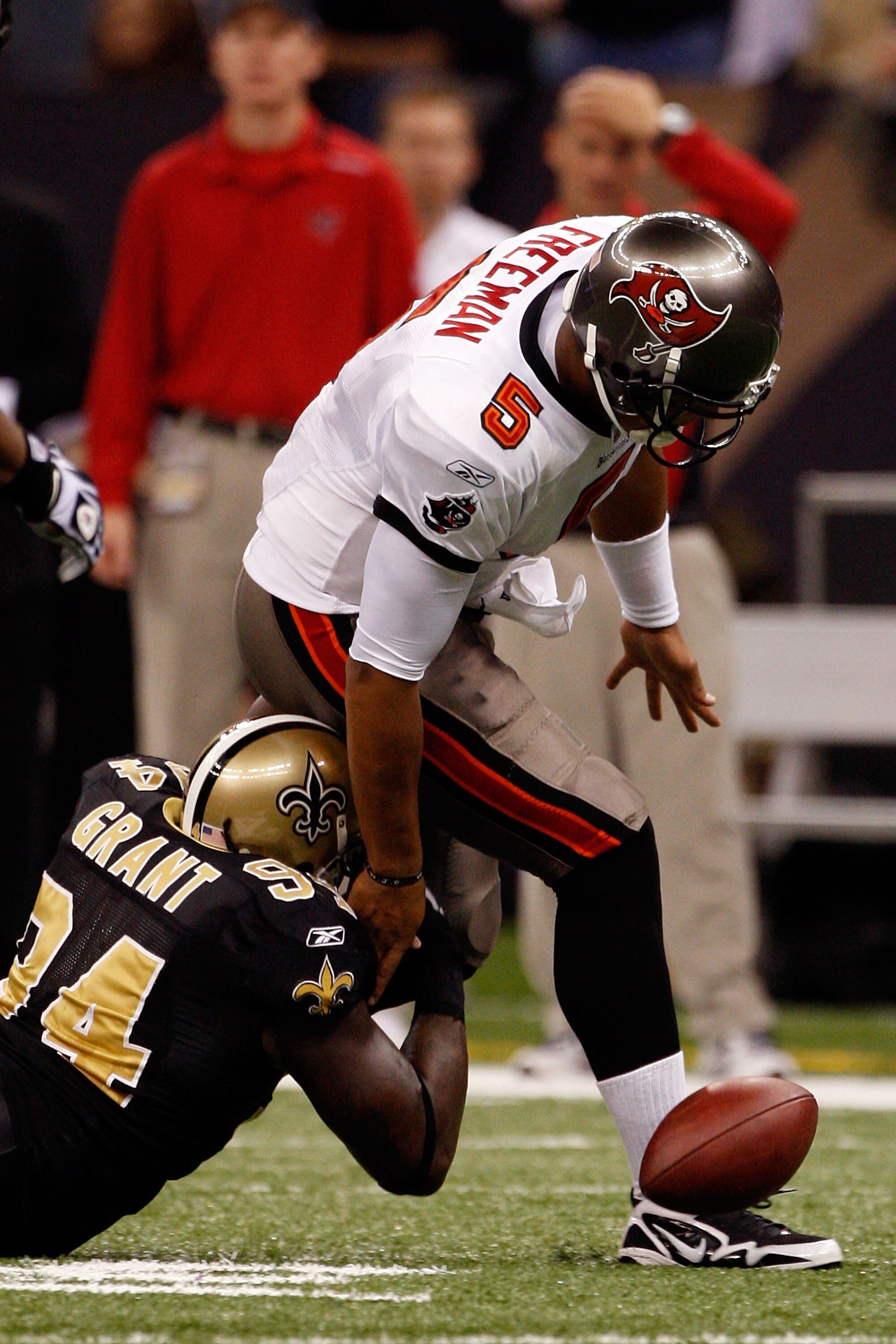 NEW ORLEANS - DECEMBER 27:  Quarterback Josh Freeman #5 of the Tampa Bay Buccaneers fumbles the ball as he is sacked by Charles Grant #94 of the New Orleans Saints at the Louisiana Superdome on December 27, 2009 in New Orleans, Louisiana.  (Photo by Chris
