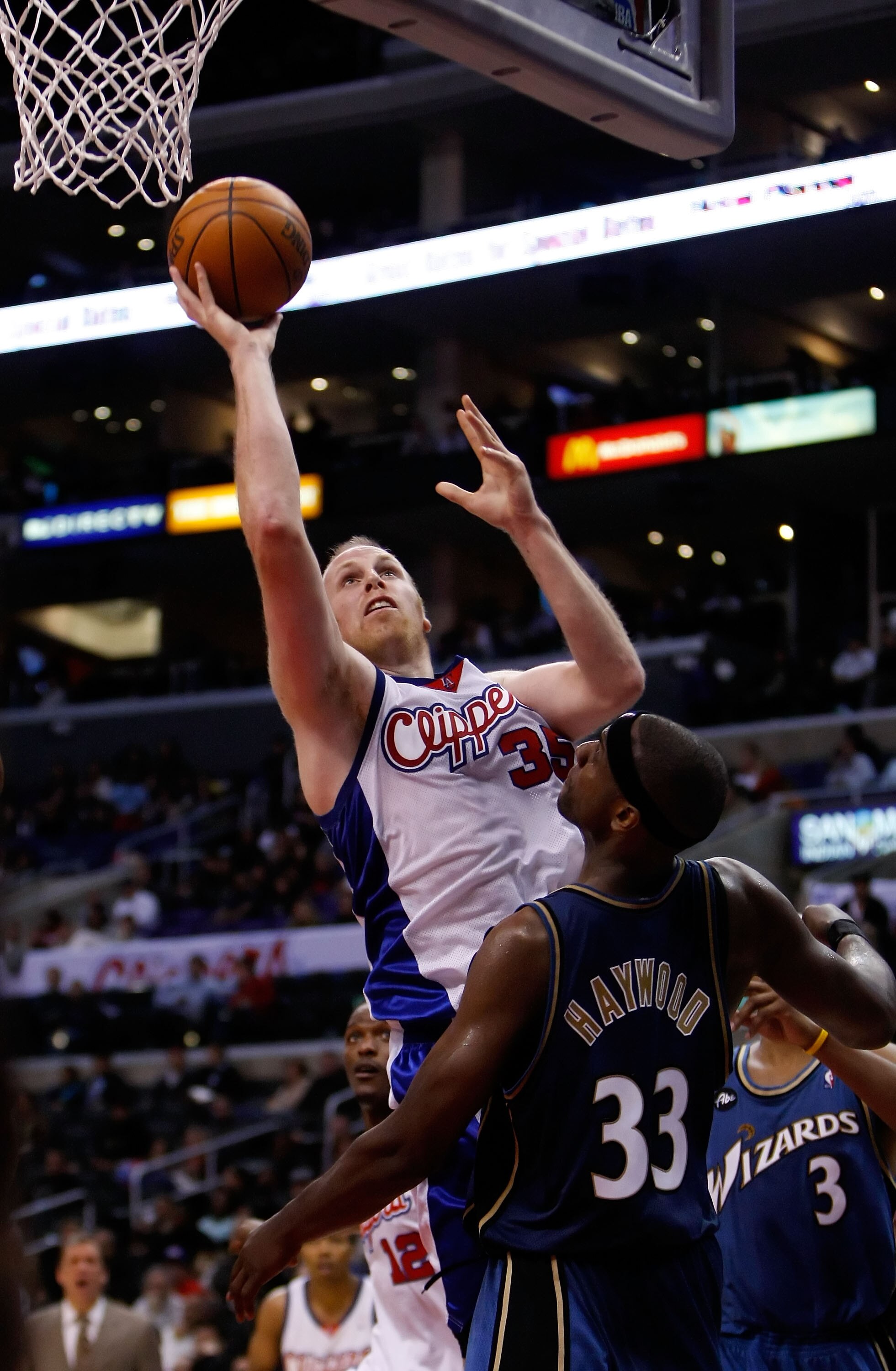 LOS ANGELES, CA - DECEMBER 14:  Chris Kaman #35 of the Los Angeles Clippers drives to the basket past Brendan Haywood #33 of the Washington Wizards in the second half at Staples Center on December 14, 2009 in Los Angeles, California. The Clippers defeated