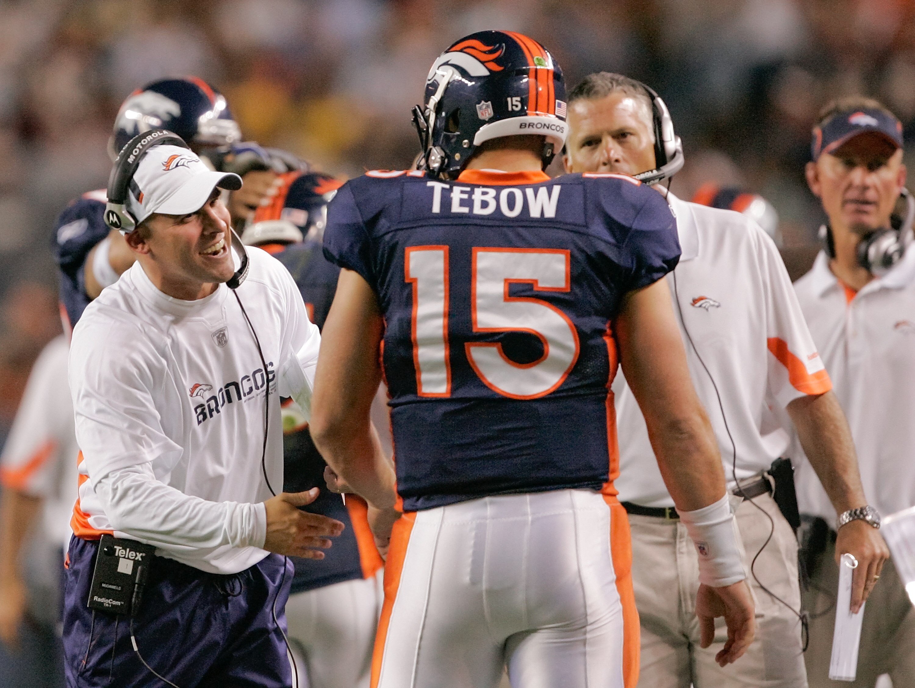 DENVER - AUGUST 29: Head coach Josh McDaniels of the Denver Broncos congratulates quarterback Tim Tebow #15 following his fourth quarter touchdown pass against the Pittsburgh Steelers at INVESCO Field at Mile High on August 29, 2010 in Denver, Colorado. DENVER - AUGUST 29: Head coach Josh McDaniels of the Denver Broncos congratulates quarterback Tim Tebow #15 following his fourth quarter touchdown pass against the Pittsburgh Steelers at INVESCO Field at Mile High on August 29, 2010 in Denver, Colorado.