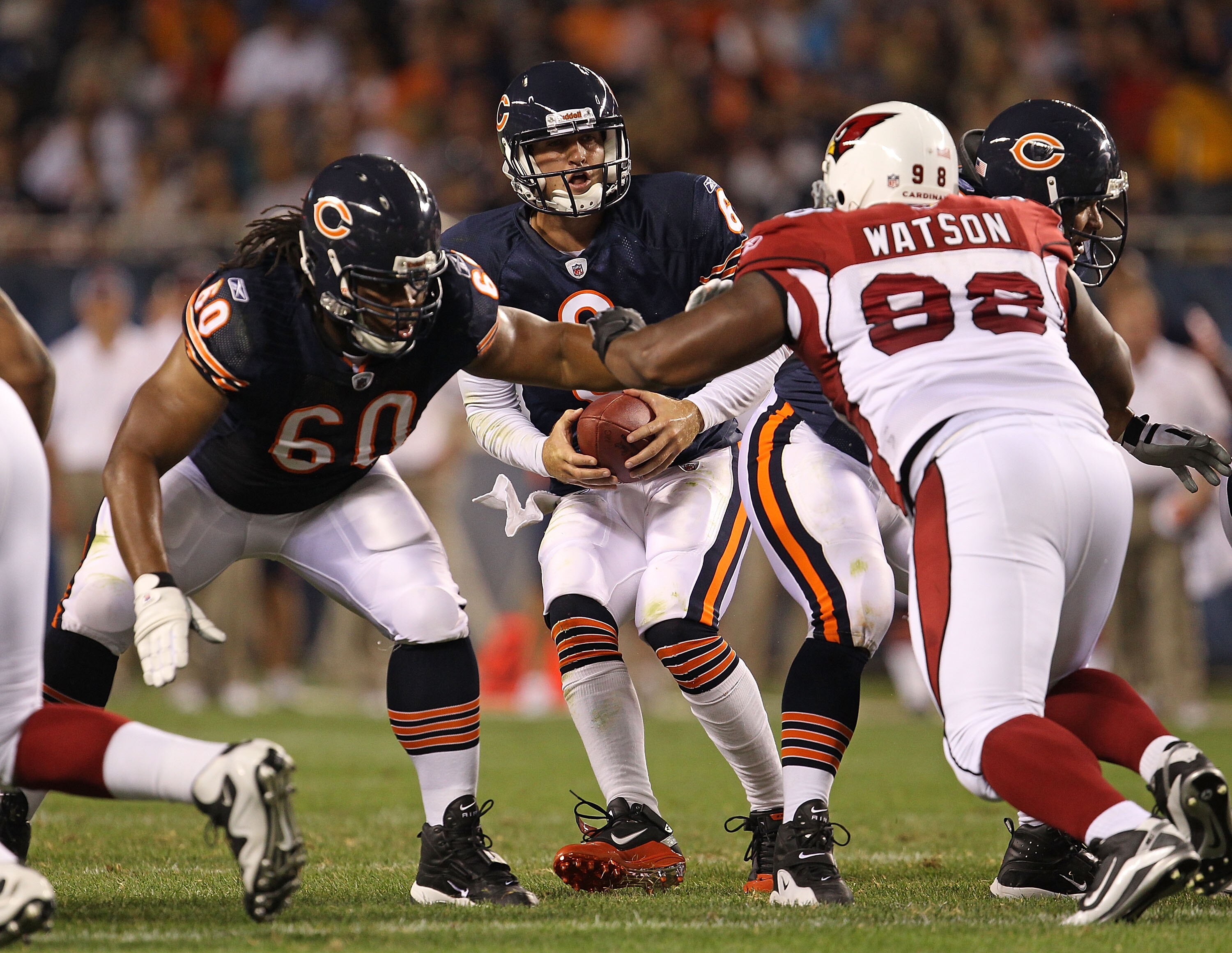 CHICAGO - AUGUST 28: Jay Cutler #6 of the Chicago Bears drops back to pass as teammate Lance Louis #60 prepares to block Gabe Watson #98 of the Arizona Cardinals during a preseason game at Soldier Field on August 28, 2010 in Chicago, Illinois. The Cardina