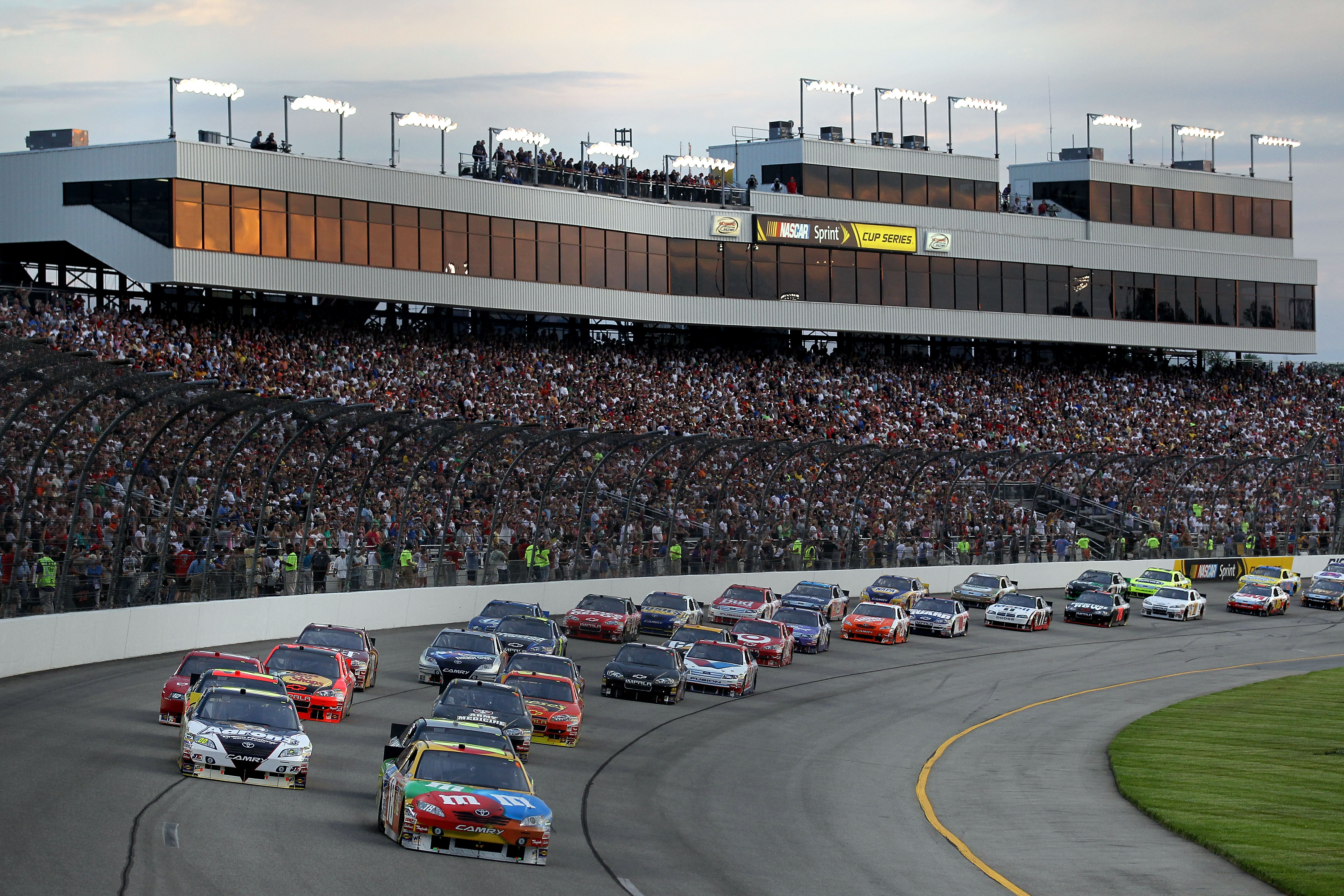 RICHMOND, VA - MAY 01:  Kyle Busch, driver of the #18 M&M's Toyota and David Reutimann (L), driver of the #00 Aaron's Dream Machine Toyota,  lead the field at the start of the NASCAR Sprint Cup Series Crown Royal Presents the Heath Calhoun 400 at Richmond