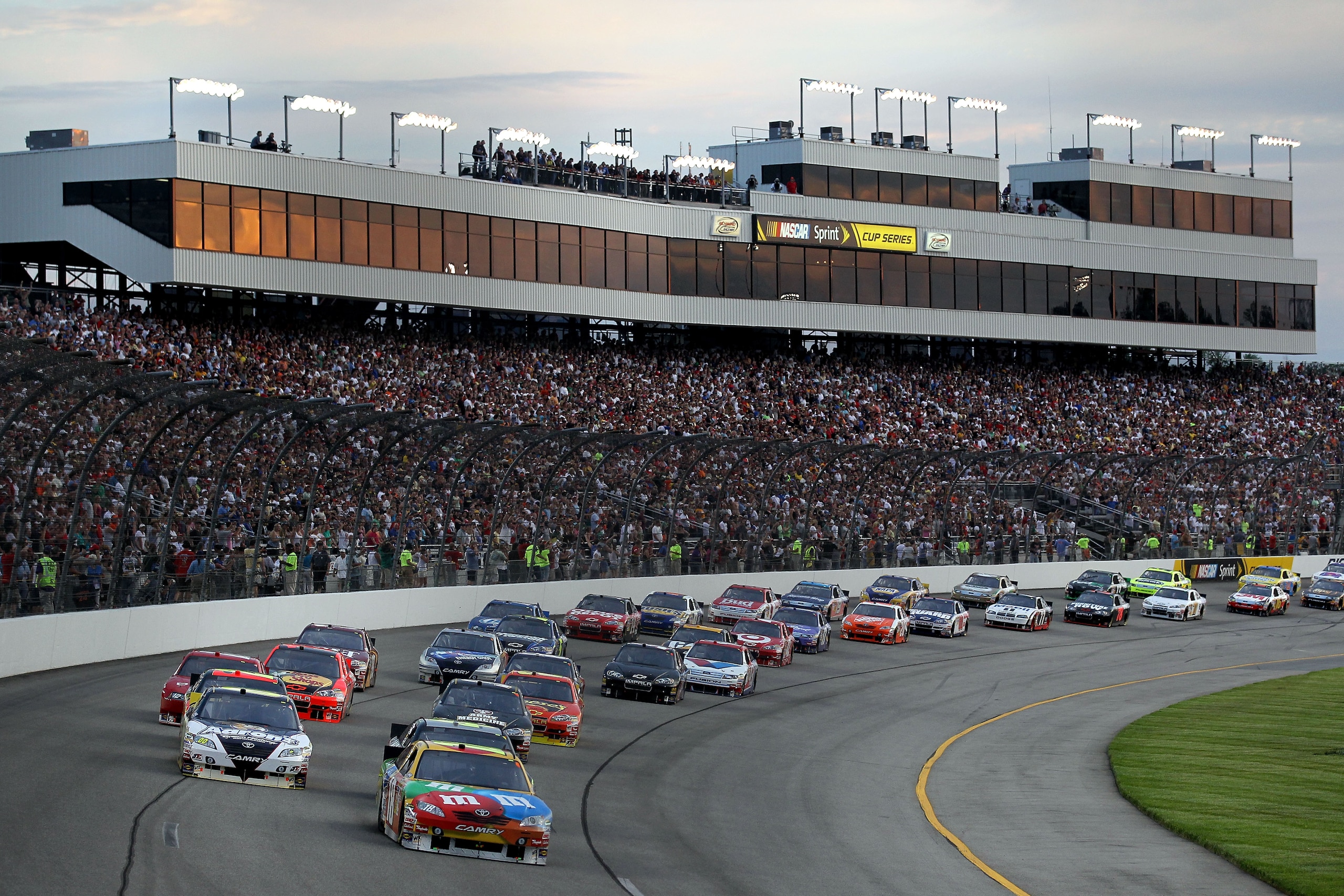 RICHMOND, VA - MAY 01:  Kyle Busch, driver of the #18 M&M's Toyota and David Reutimann (L), driver of the #00 Aaron's Dream Machine Toyota,  lead the field at the start of the NASCAR Sprint Cup Series Crown Royal Presents the Heath Calhoun 400 at Richmond
