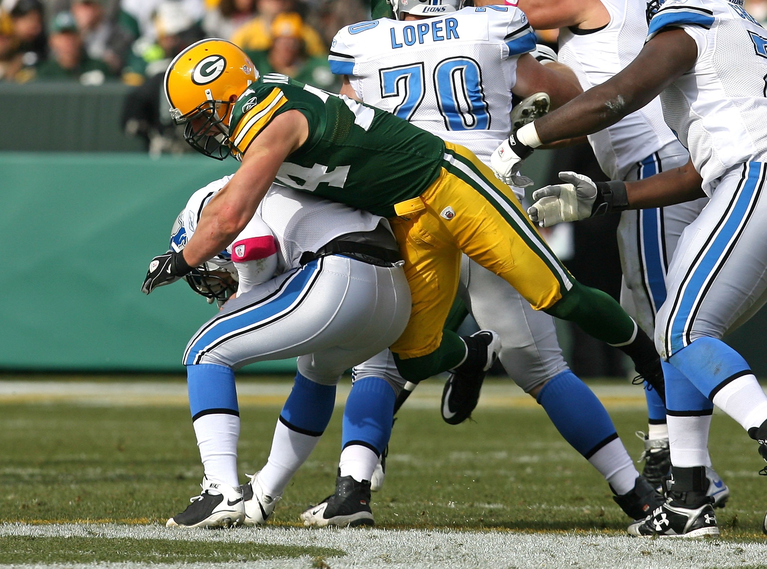 GREEN BAY, WI - OCTOBER 18: Aaron Kampman #74 of the Green Bay Packers sacks Duante Culpepper #11 of the Detroit Lions at Lambeau Field on October 18, 2009 in Green Bay, Wisconsin. The Packers defeated the Lions 26-0. (Photo by Jonathan Daniel/Getty Image
