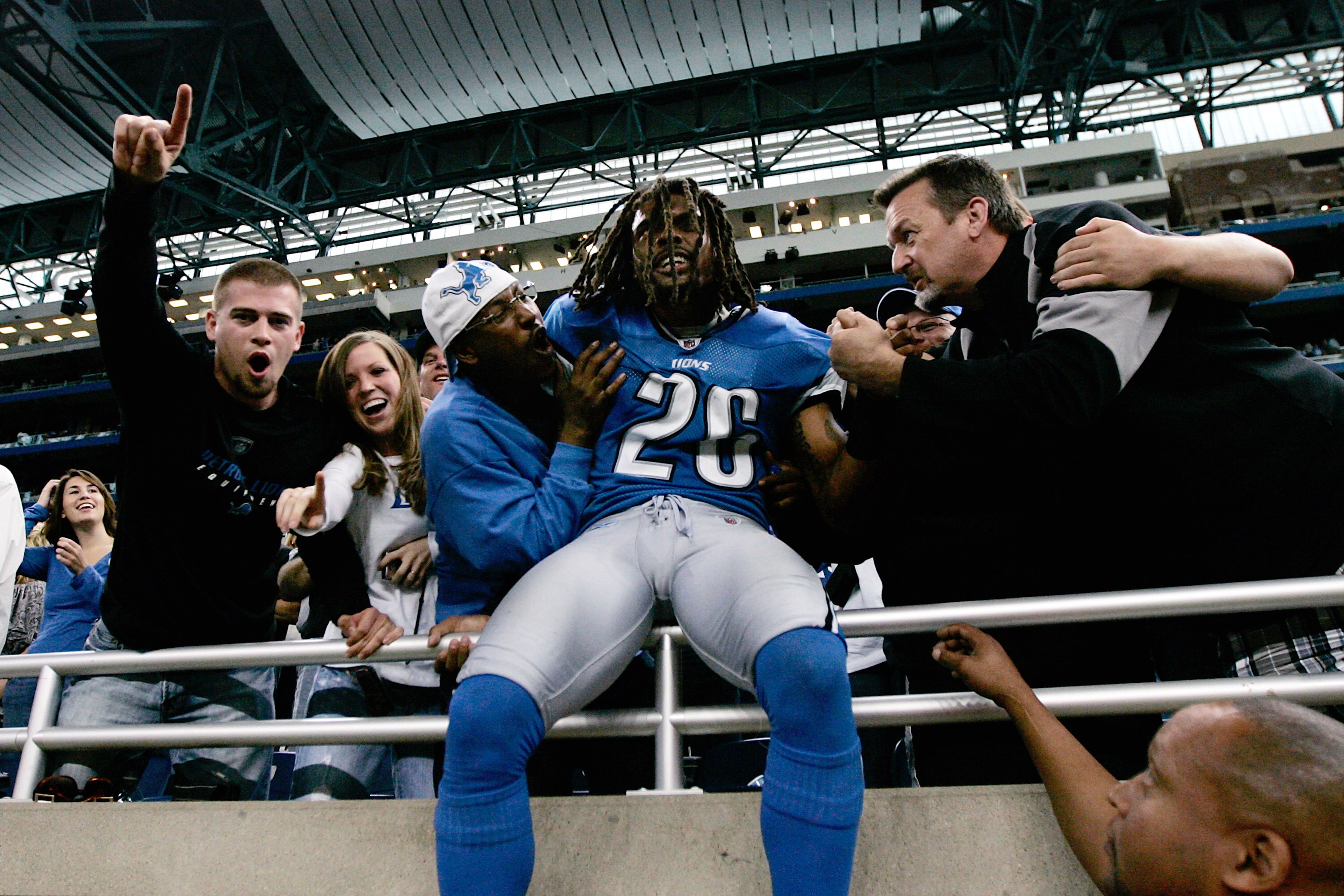 DETROIT, MI - SEPTEMBER 27: Defensive back Louis Delmas #26 of the Detroit Lions celebrates with fans after the victory against the Washington Redsklns at Ford Field on September 27, 2009 in Detroit, Michigan. The Lions defeated the Redskins 19-14. (Photo
