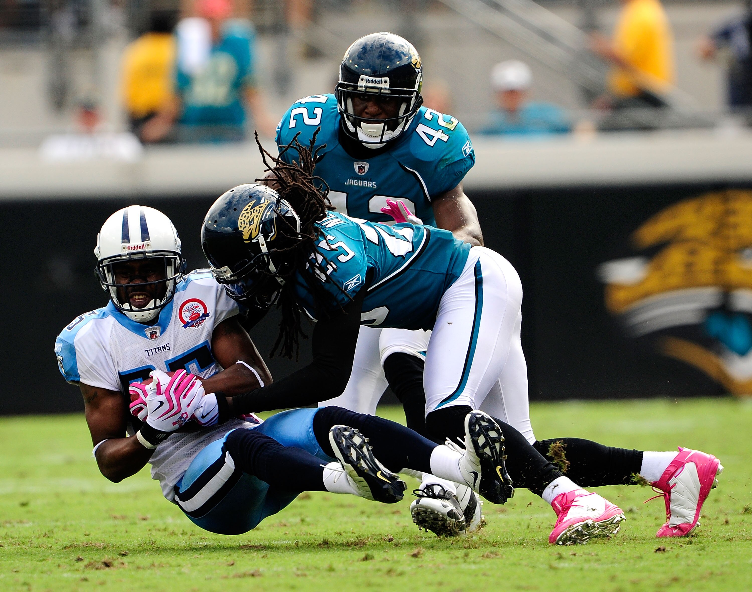 JACKSONVILLE, FL - OCTOBER 04:  Nate Washington #85 of the Tennessee Titans is tackled by Reggie Nelson #25 of the Jacksonville Jaguars during the game at Jacksonville Municipal Stadium on October 4, 2009 in Jacksonville, Florida.  (Photo by Sam Greenwood
