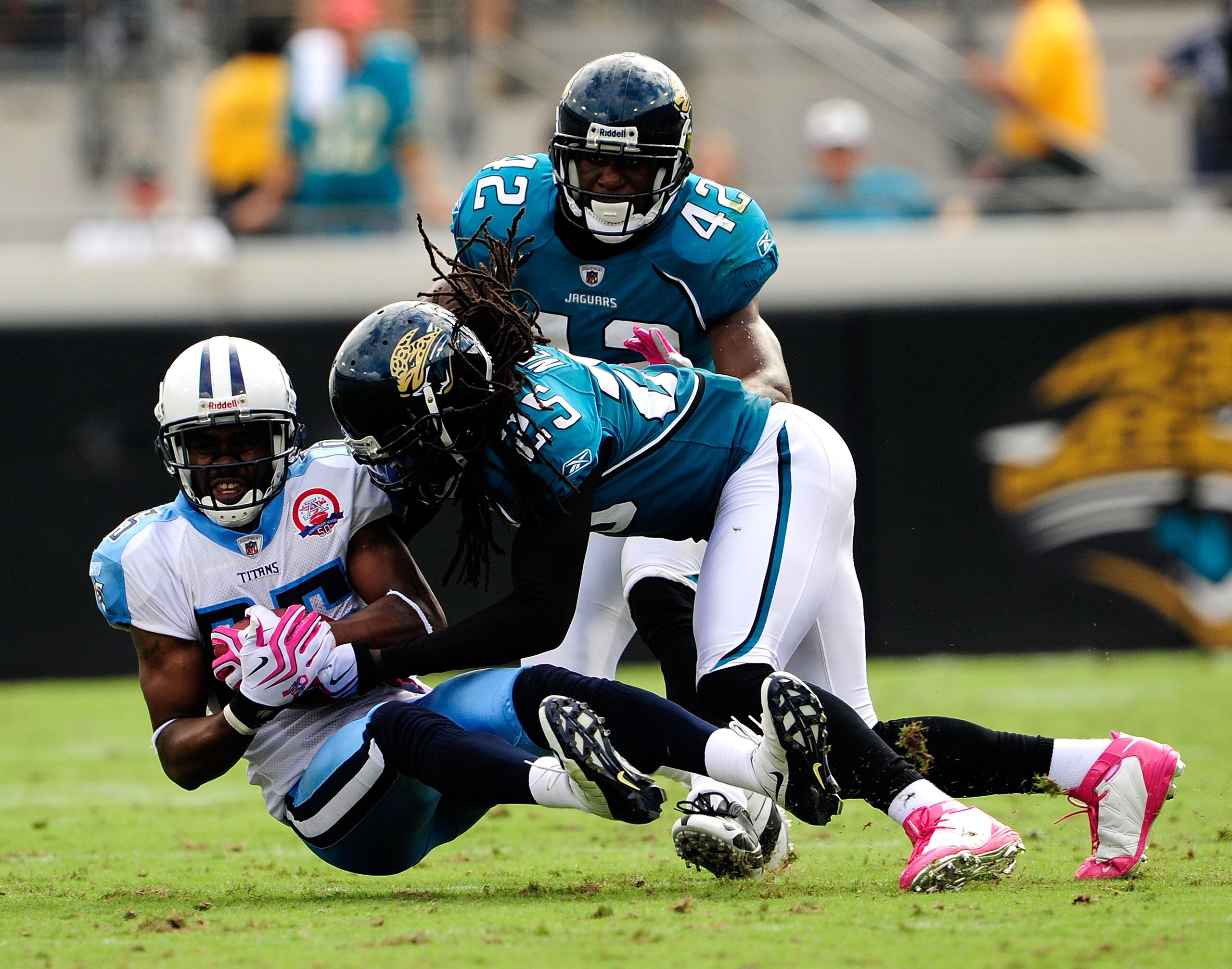 JACKSONVILLE, FL - OCTOBER 04:  Nate Washington #85 of the Tennessee Titans is tackled by Reggie Nelson #25 of the Jacksonville Jaguars during the game at Jacksonville Municipal Stadium on October 4, 2009 in Jacksonville, Florida.  (Photo by Sam Greenwood